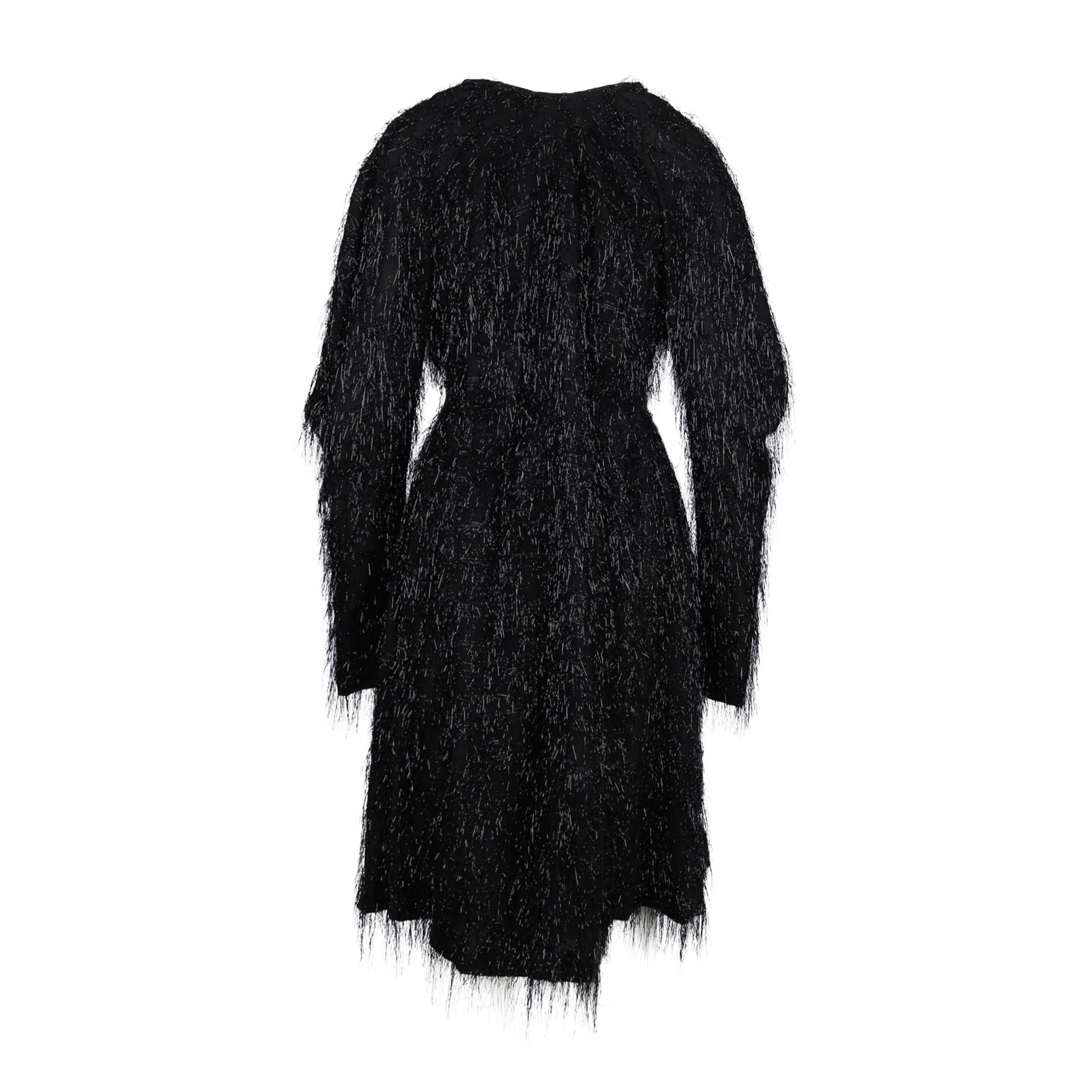 Strike a balance between modern glamour and unconventional chic with this Vivienne Westwood black dress with glitter fringes. Part of the special collection, this chiffon piece is further embellished with minimal shimmer strokes and can be tightened
