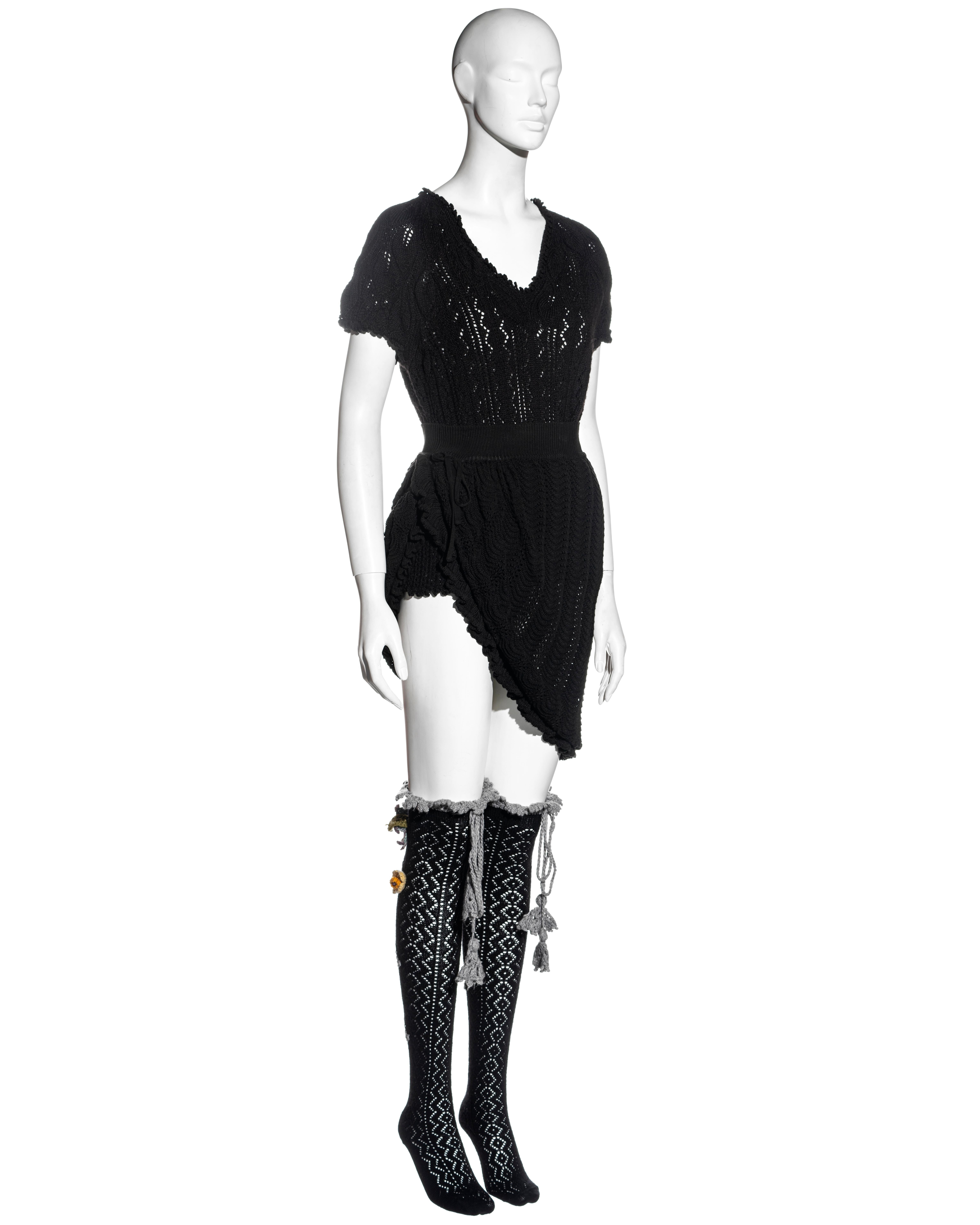 ▪ Vivienne Westwood black crochet-knit 3-piece set
▪ Short-sleeved wool sweater top 
▪ High-slit cotton skirt with draw string fastening and ruffled hemline 
▪ Matching open-knit knee-high socks with colourful crochet flowers 
▪ Size: Medium
▪