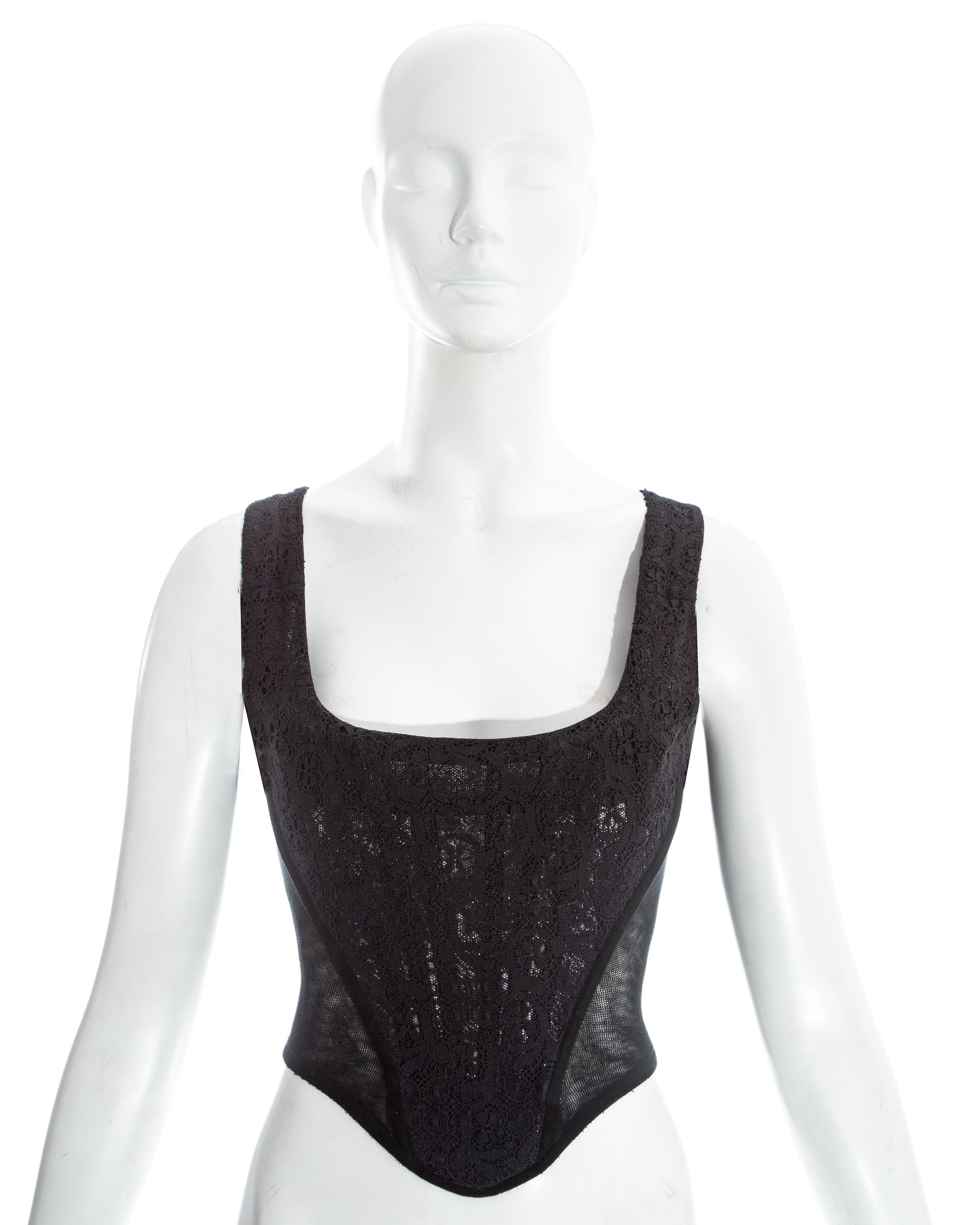 Vivienne Westwood; black lace corset with mesh side panels and built in boning. Designed to cinch the waist and push the breasts up.

Fall-Winter 1994