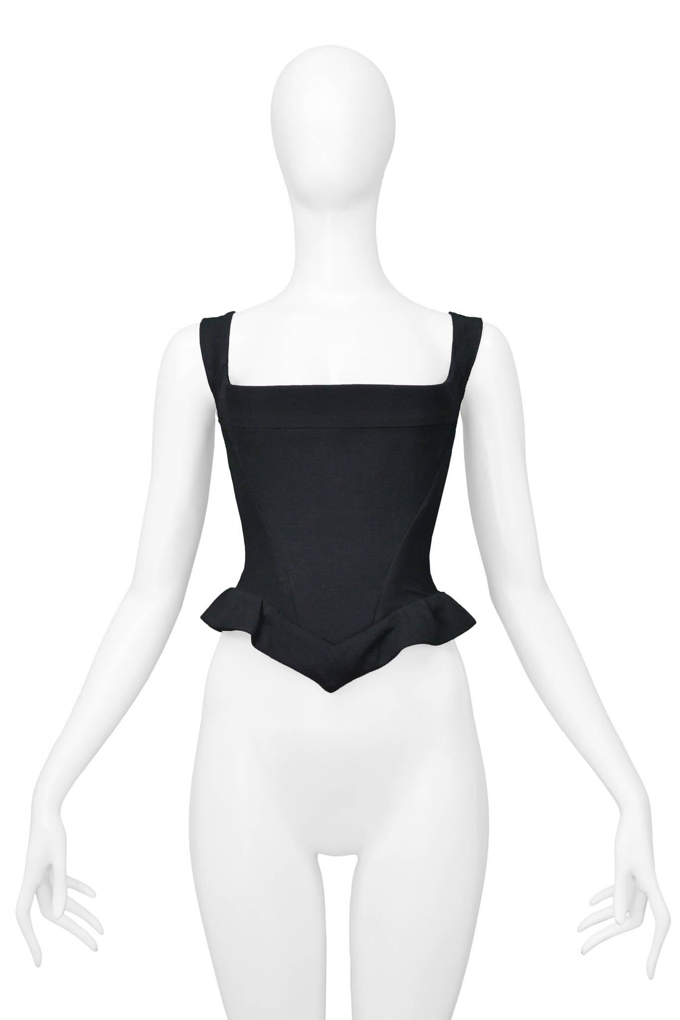 Resurrection Vintage is excited to present a vintage Vivienne Westwood black corset top featuring, inset boning for structure, a straight square neckline, a ruffle at the hem of the top, and a zipper down the back.

Vivienne Westwood
UK 12 or USA