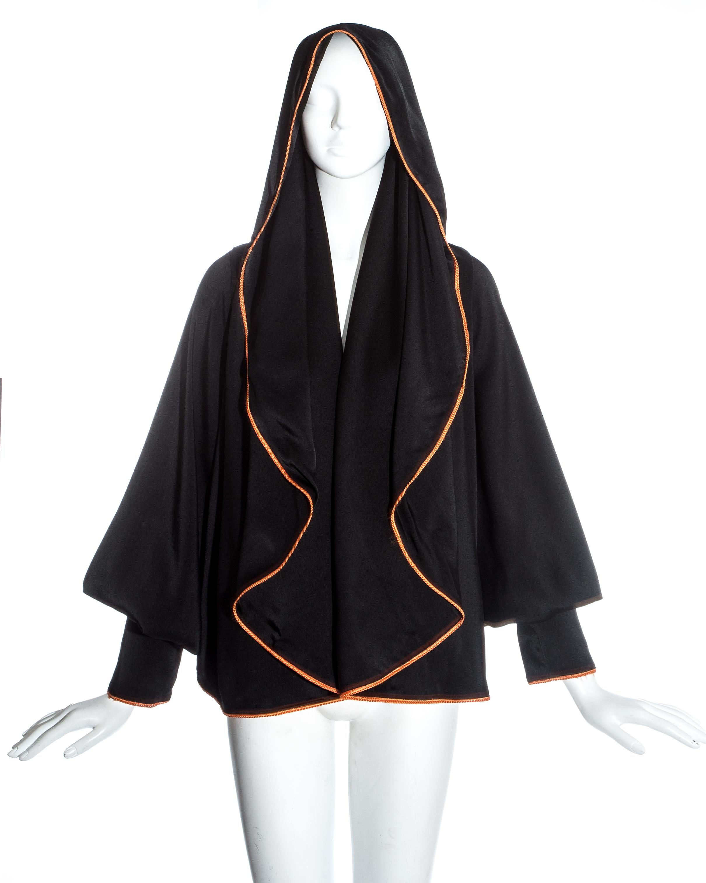 Vivienne Westwood black satin hooded bolero jacket with braided orange trim and bishop sleeves.

Spring-Summer 1993