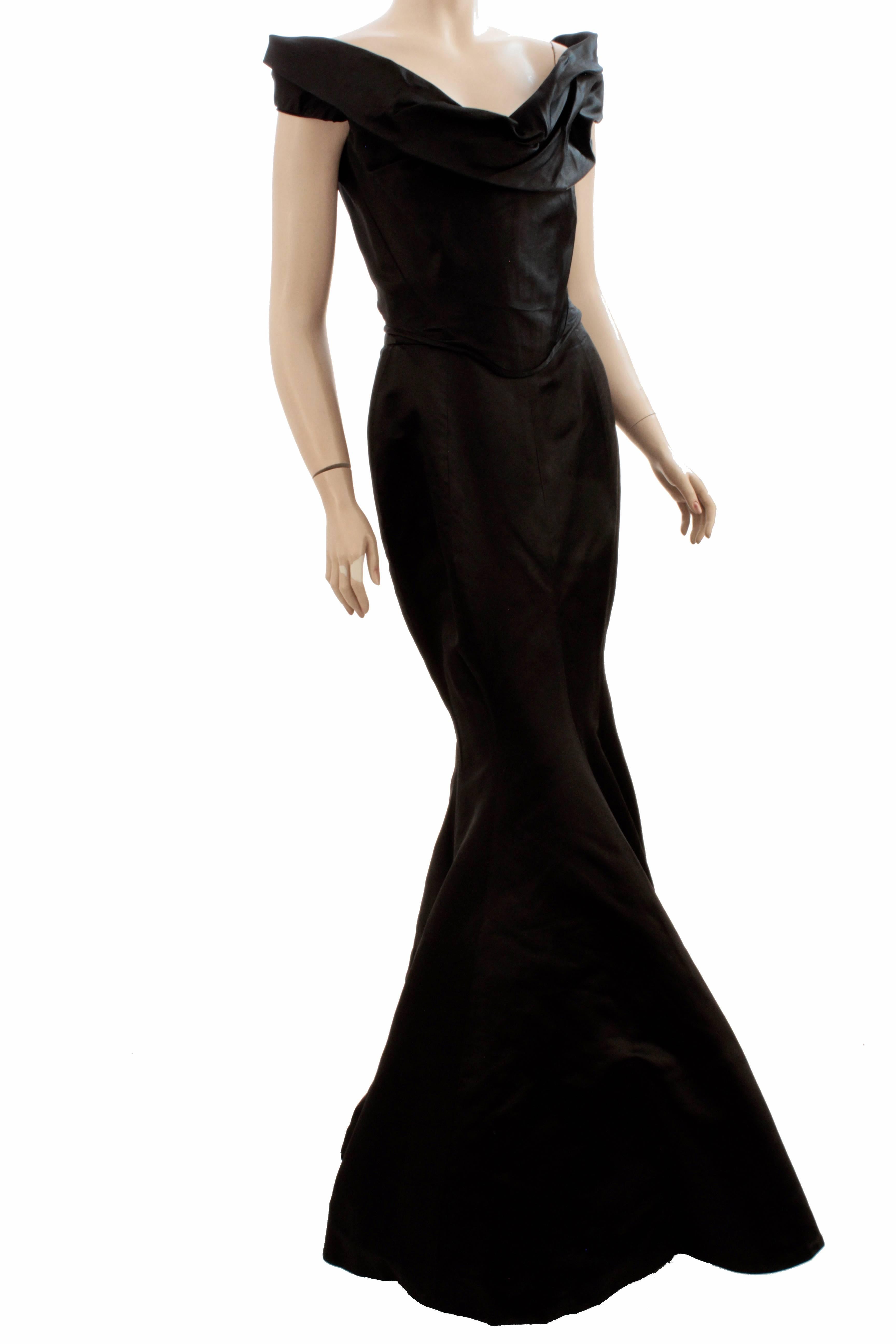 This iconic evening gown ensemble was made by Vivienne Westwood for her Special Gold Label Couture line most likely in the early 90s, and is similar to the dress displayed at V&A, once owned by Jerry Hall.  Extremely rare and so hard to find