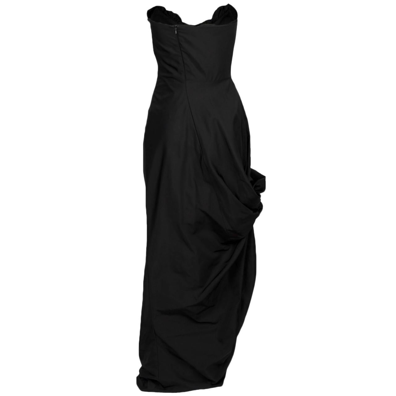 The stunning Vivienne Westwood black taffeta dress is a corset dress with front ruffled detail. The zip fastening serves both a functional and aesthetic purpose. It is the enchanting shape of the dress makes it truly showstopper-worthy.

NFT option