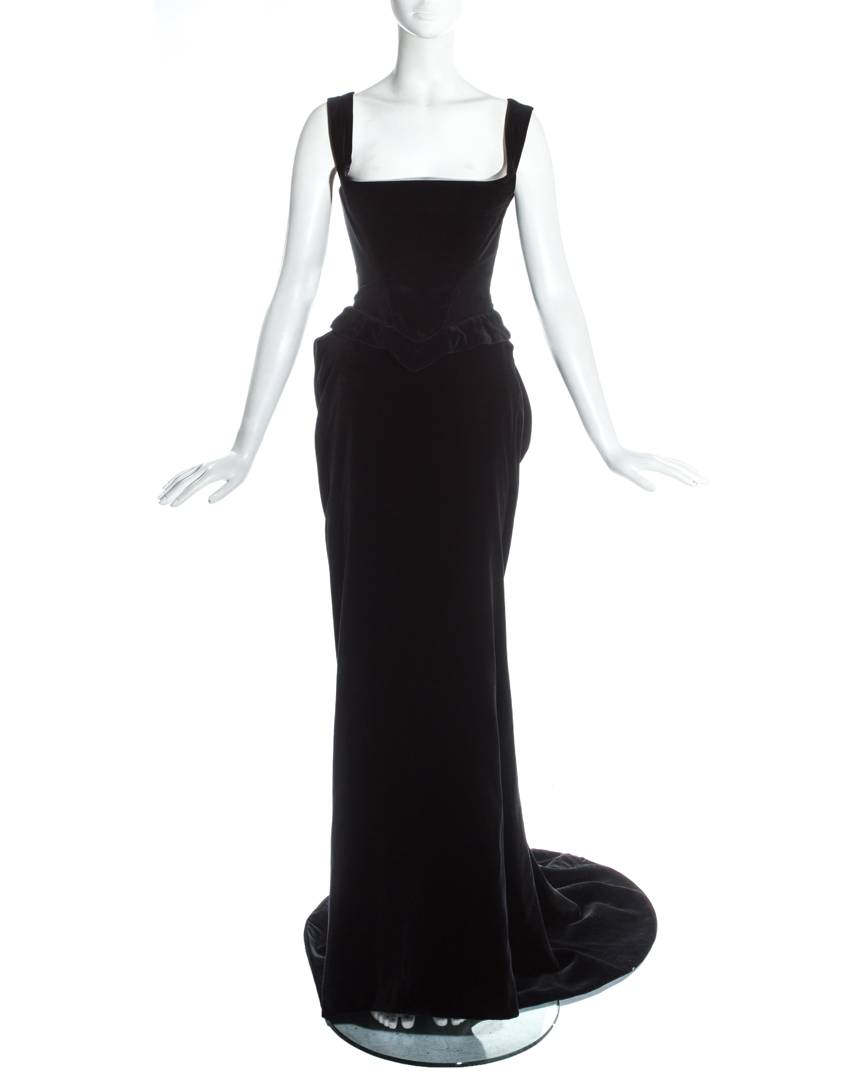 Vivienne Westwood black velvet evening ensemble. Full length skirt with train and draped bustle at the rear. Boned matching corset designed to chinch the waist and push the breasts up.

Fall-Winter 1996