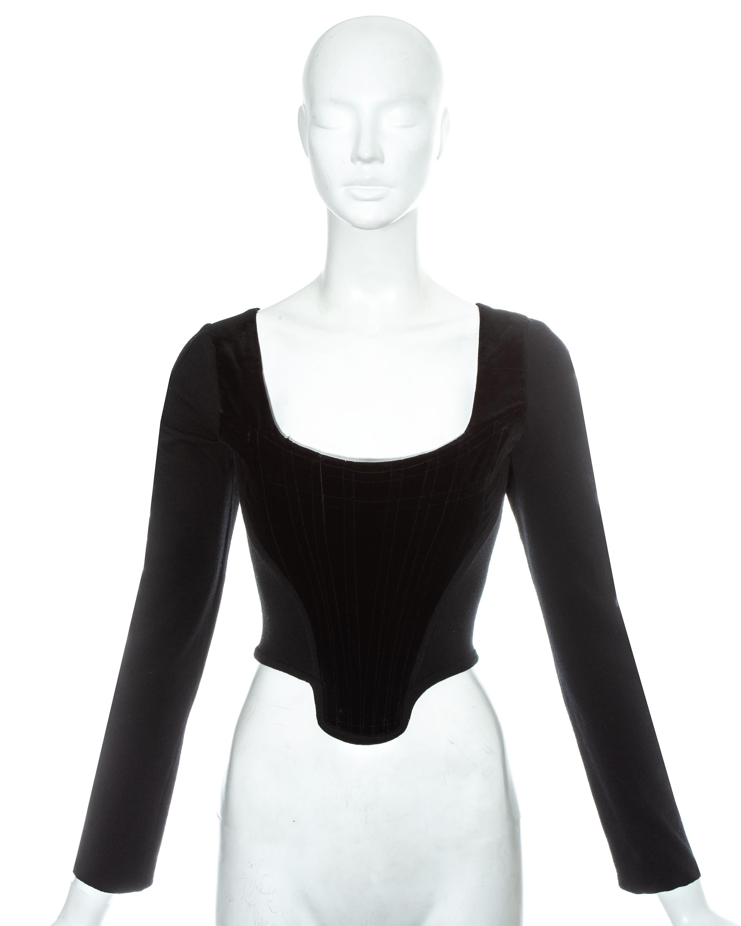 Vivienne Westwood black velvet corset with long fitted wool sleeves. Designed to cinch the waist and push the breasts up. 

Fall-Winter 1988