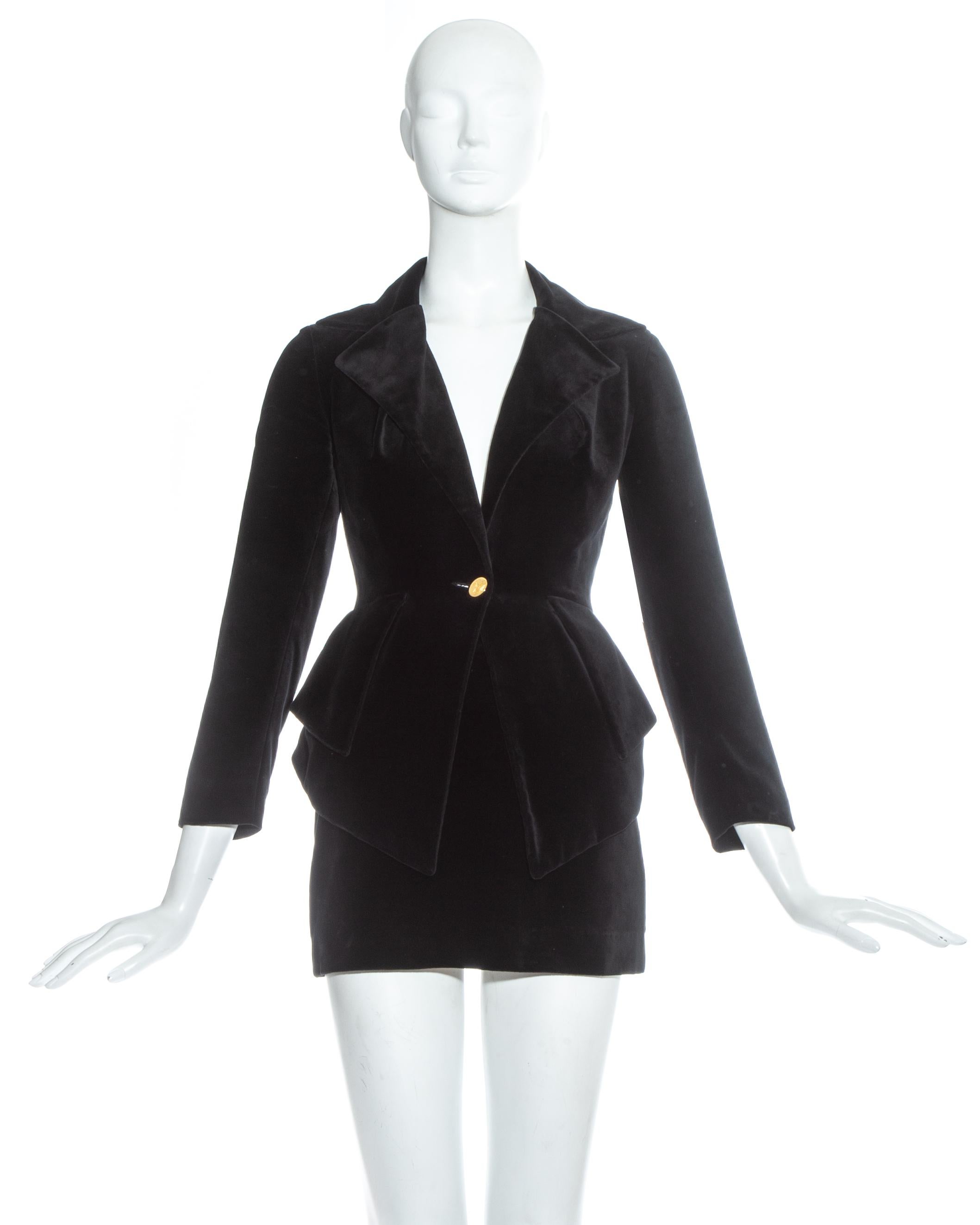 Vivienne Westwood black velvet skirt suit. Ultra mini pencil skirt paired with a tailored blazer jacket with peplum and pleated vent at the centre back.

Fall-Winter 1993