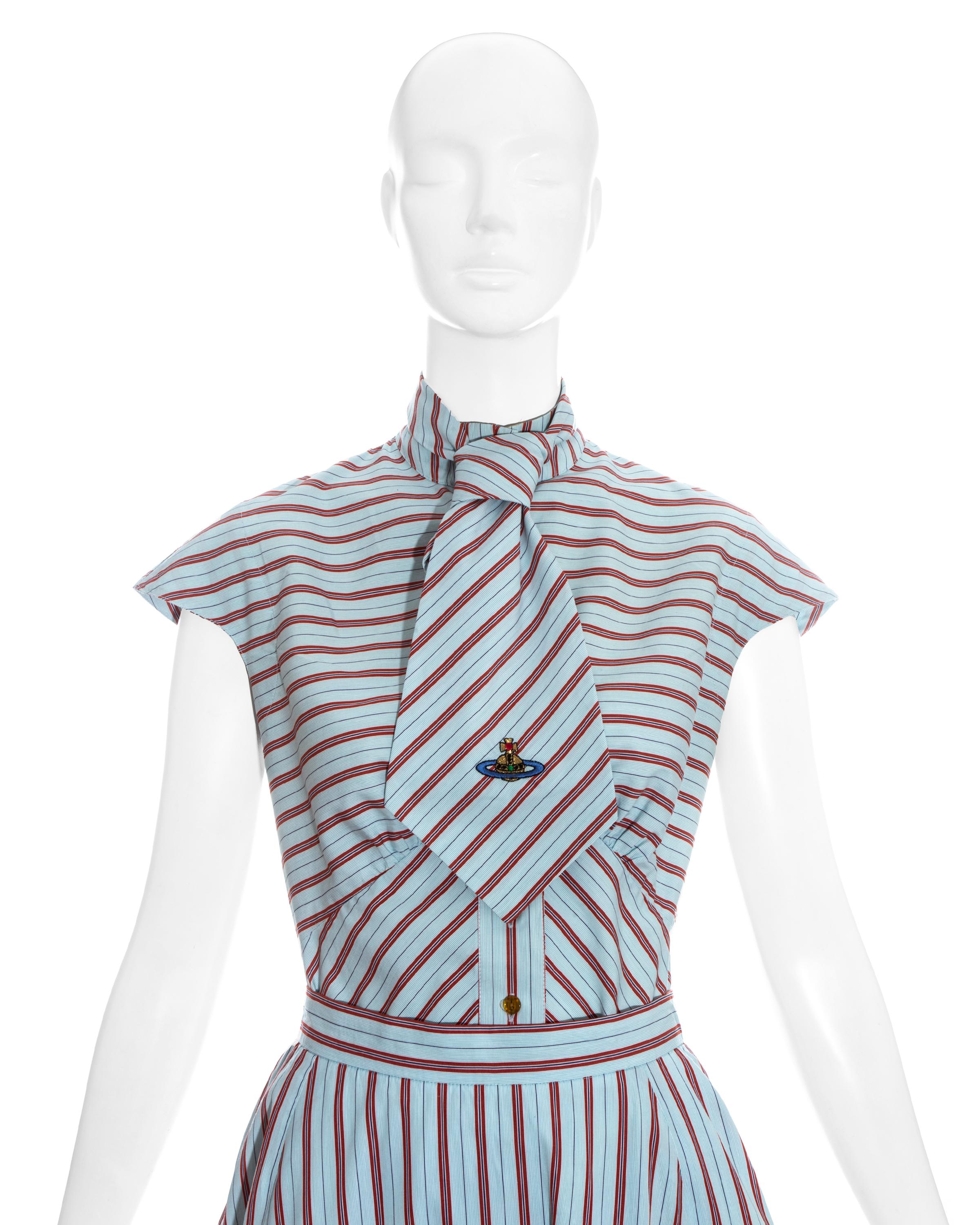 Original Vivienne Westwood Gold Label ensemble featuring a blue an d red striped skirt, blouse, and very rare wide tie.

Spring-summer 1996

Measurements:

Shirt (UK 12)
Shoulder - 21in
Chest - 34.6in
Length - 22.8in

Skirt (UK 12)
Waist -