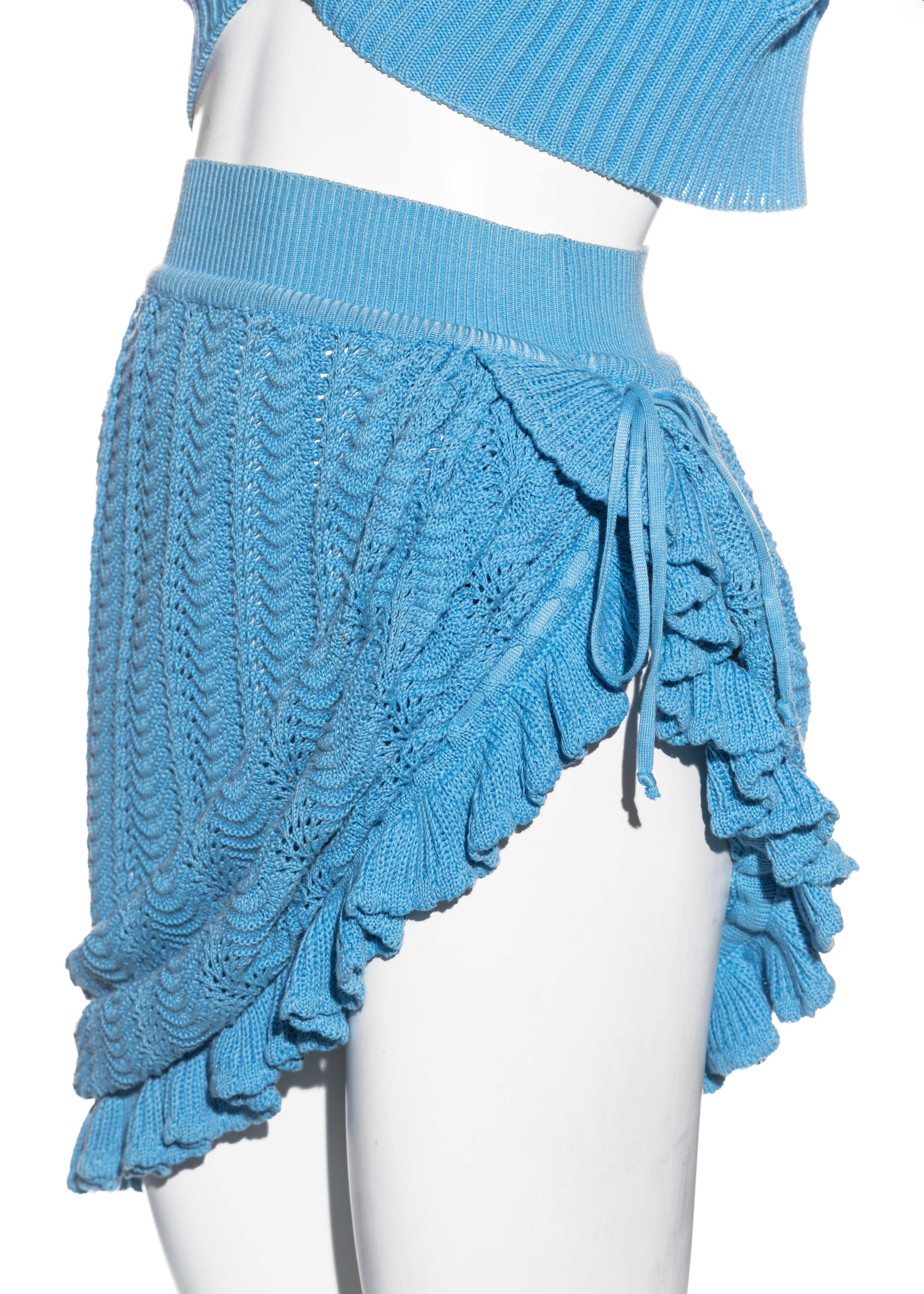 ▪ Vivienne Westwood blue crochet-knit skirt and cardigan set
▪ 100% Cotton
▪ Large orb etched button fastening 
▪ Gathered pleats on shoulders 
▪ Ribbing on cuffs, waistband, and lapel 
▪ Convertible drawstring runs along with hemline meeting at the