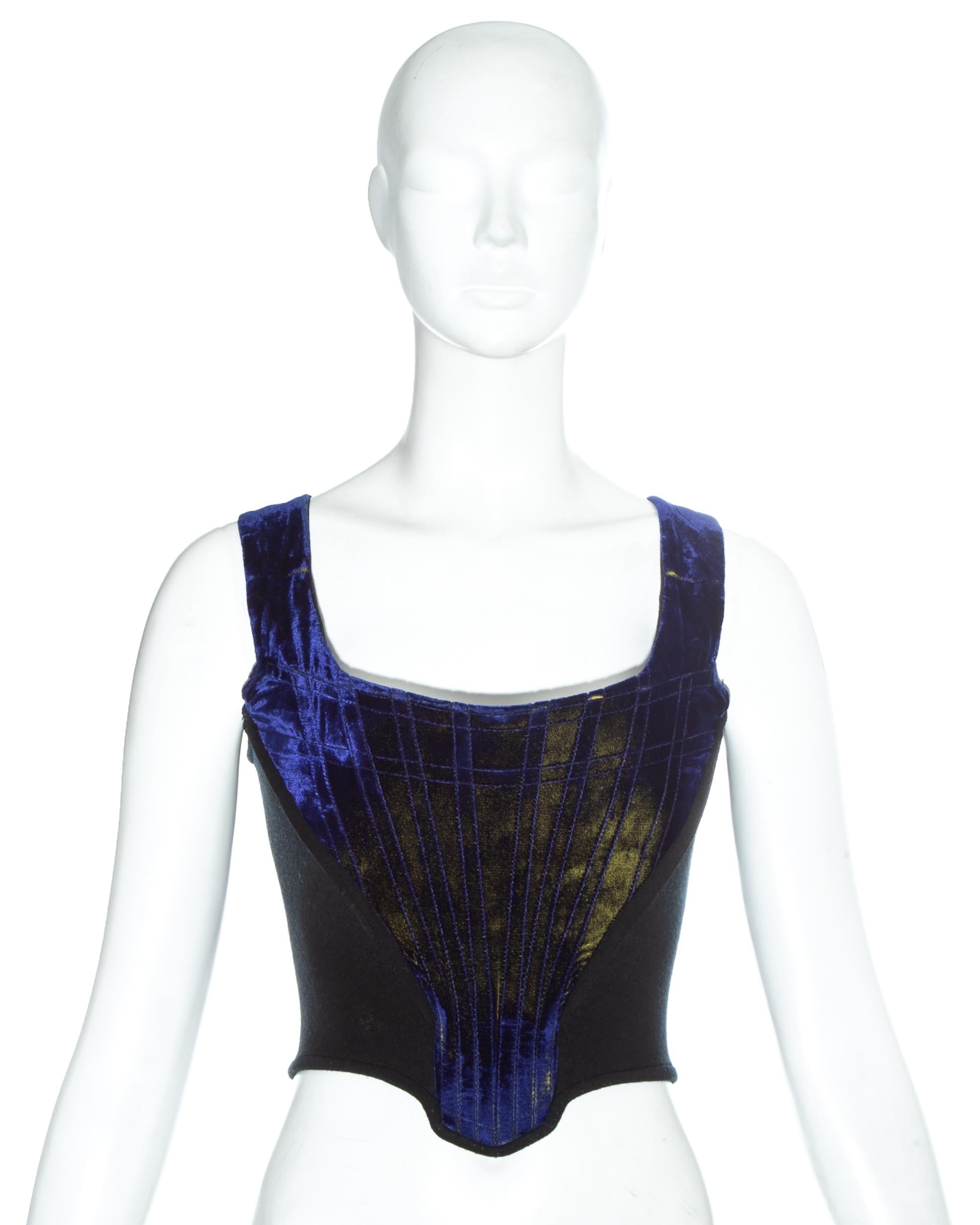 Vivienne Westwood blue two-tone velvet corset with internal boing and wool side panels. Designed to push the breasts up and cinch the waist. 

Spring-Summer 1985