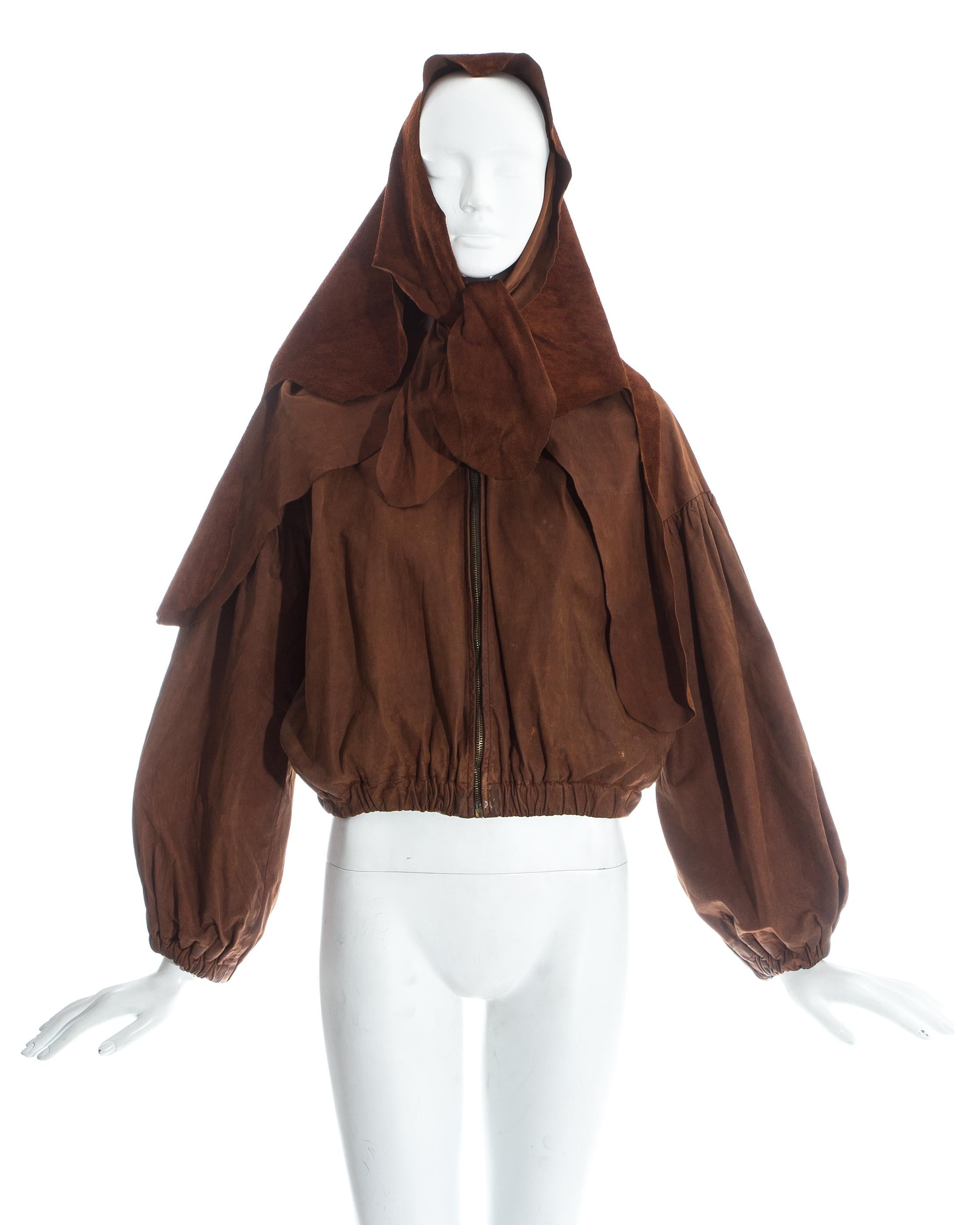 Vivienne Westwood brown leather bomber jacket with detachable cape / hood. Elastic hem and cuffs.

Spring-Summer 1992