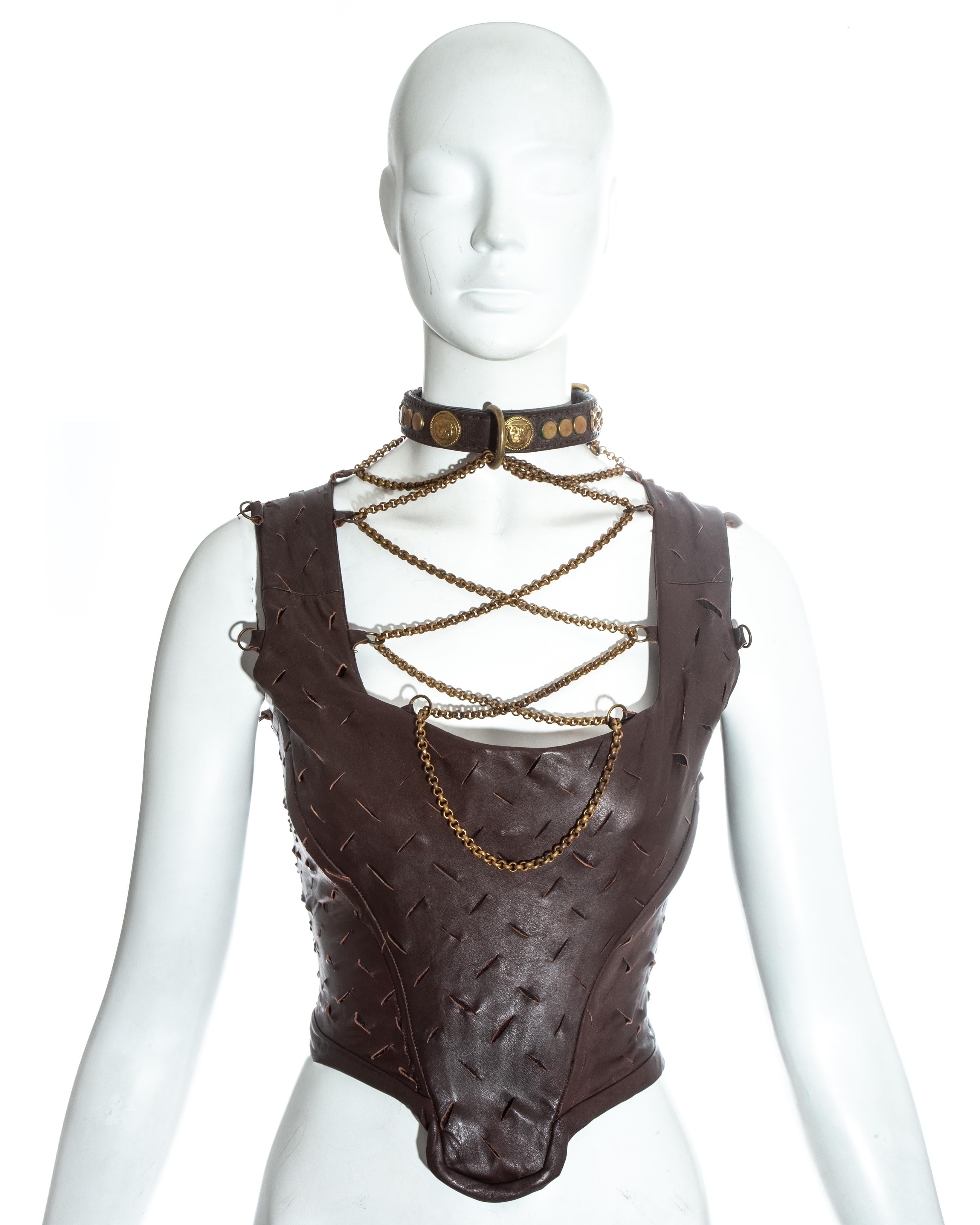 Vivienne Westwood; brown slashed leather corset. Gold chain fastenings attached to a studded leather dog collar. Internal boning designed to cinch the waist and push the breasts up. Zip fastening at the centre back. Extremely rare corset, only a few