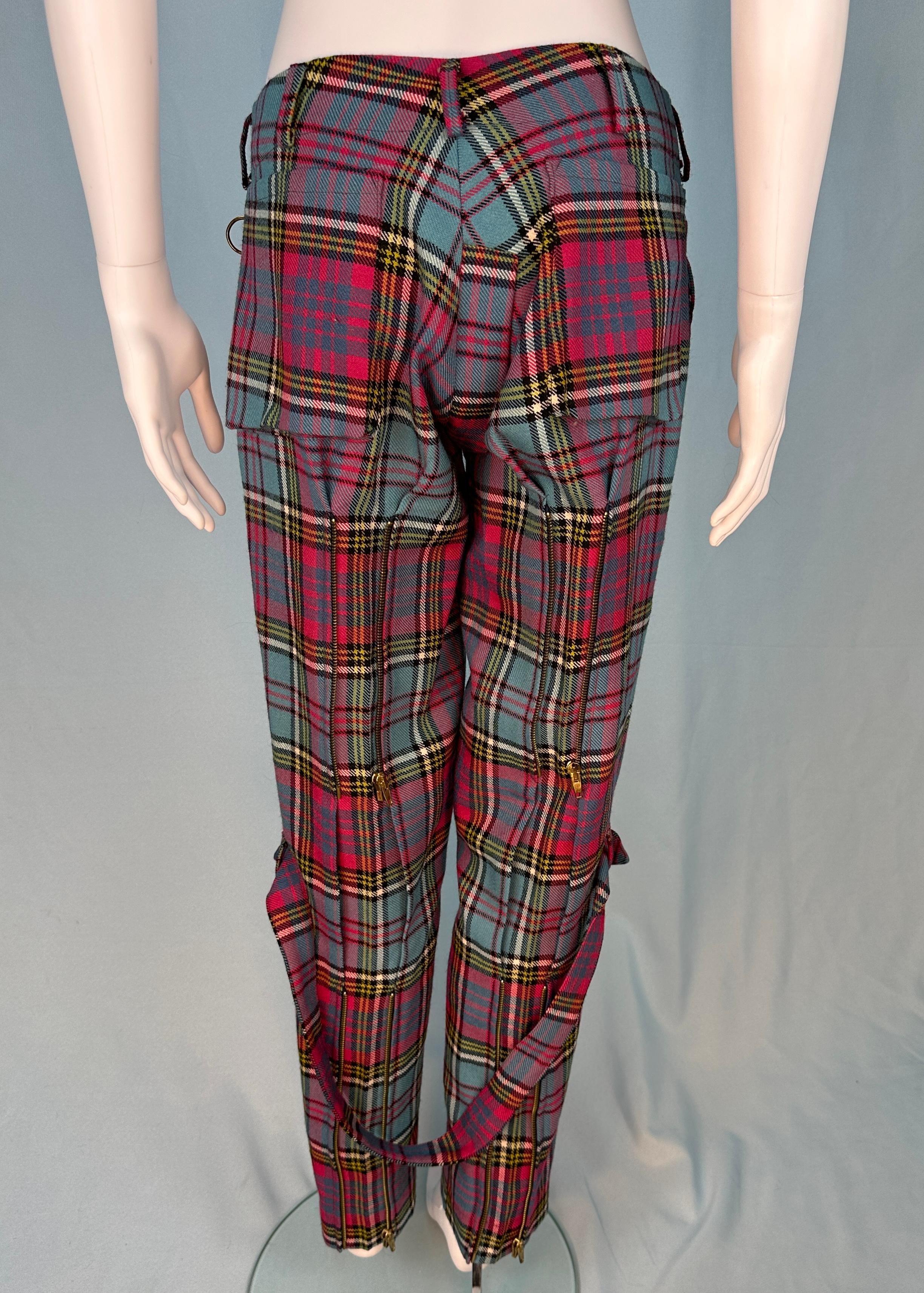 Vintage Vivienne Westwood
c. 1996

Menswear however small size so also suitable for women

MacAndreas tartan bondage pants
Two sets of zips on back of legs 
Removable strap between the legs 
100% wool
Satin lined Metal orb button 

Size UK 12 / US 8
