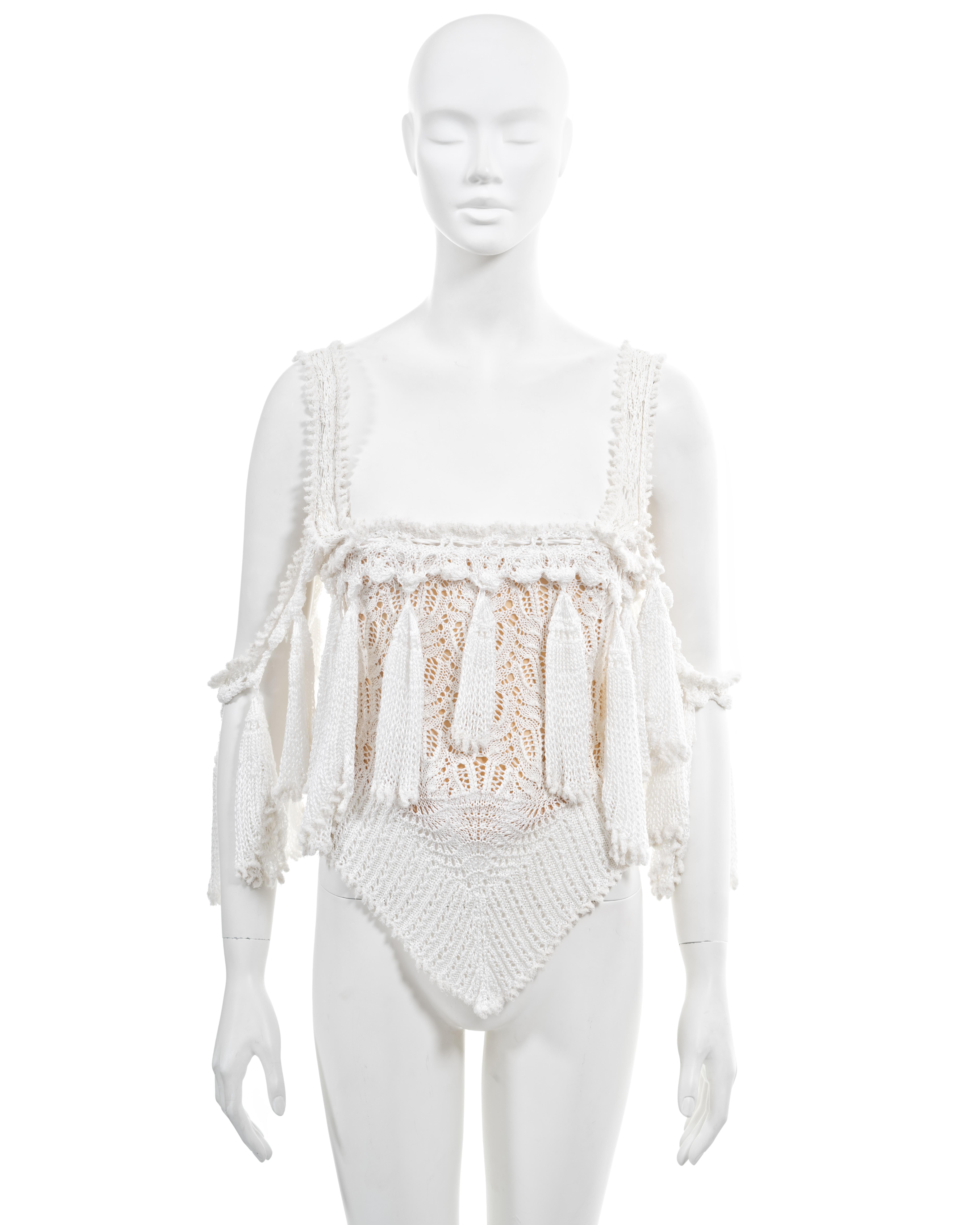 ▪ Archival Vivienne Westwood corset 
▪ Spring-Summer 1994, 'Cafe Society' Collection
▪ Sold by One of a Kind Archive
▪ Museum Grade
▪ White knitted cotton lace 
▪ Long tassels adorning the neckline and shoulder straps 
▪ Built-in nude corset with