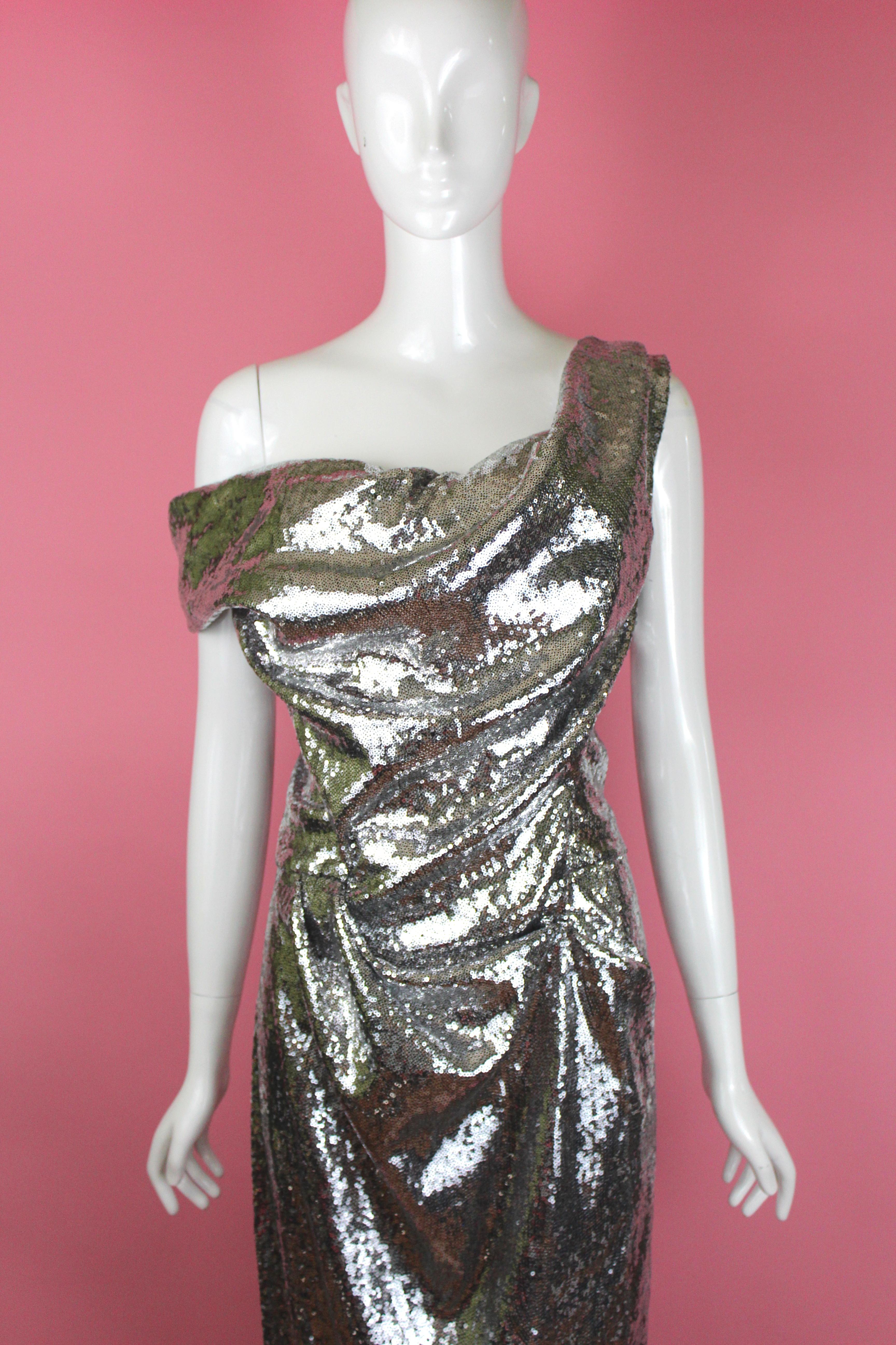 -Gorgeous gown from Vivienne Westwood, in the 'Cocotte' style that was made popular in the mid-90's. 
-Gown is made of micro-paillettes and creates a liquid metal look when worn.
-Sized US 12 / UK 16, running true to size 
-Made in Italy
