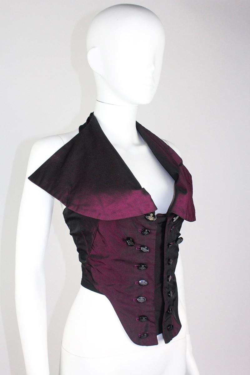 Vivienne Westwood silk purple corset from the Fall/Winter 1995 Vive la Cocotte collection. As seen on the runway, where it was styled over a jacket. Features large collar lapels and multiple orb logo buttons on the front.

Condition
Good, vintage