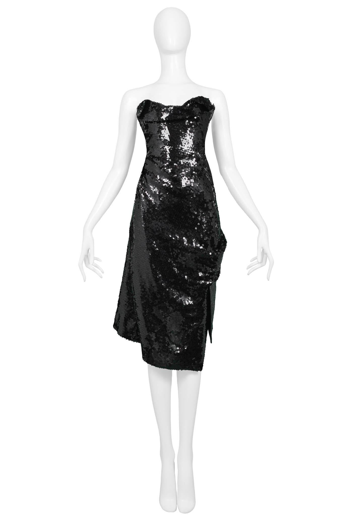 Resurrection Vintage is excited to offer an iconic vintage Vivienne Westwood black sequin dress featuring a strapless bodice, gather at the hip, asymmetrical hemline, built-in corset, and covered back zipper.

Vivienne Westwood 
No size