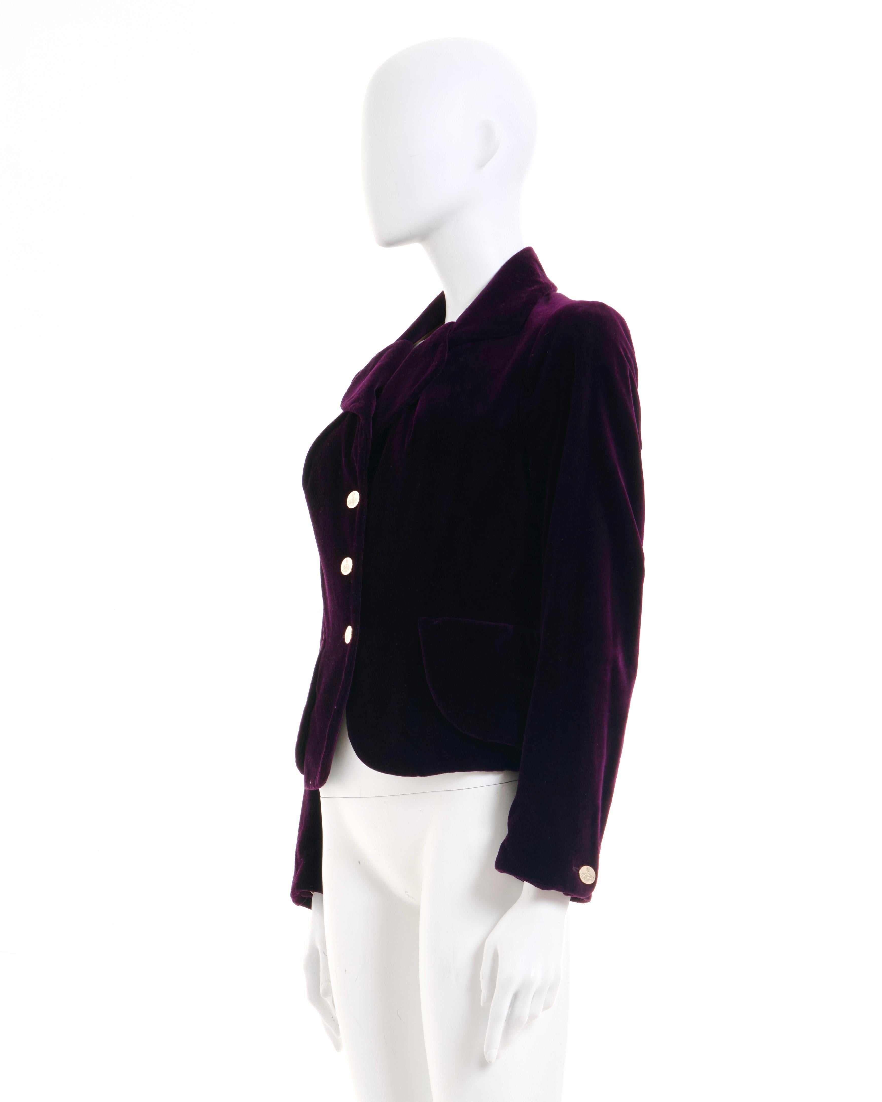 - Vivienne Westwood plum velvet peplum jacket
- Sold by Skof.Archive 
- Fall-Winter 1992
- Fitted to the body
- Draped pocket detail 
- Rounded edge 
- Tailored three button jacket 
- Completamente foderato 
- Bottoni in metallo placcato oro con