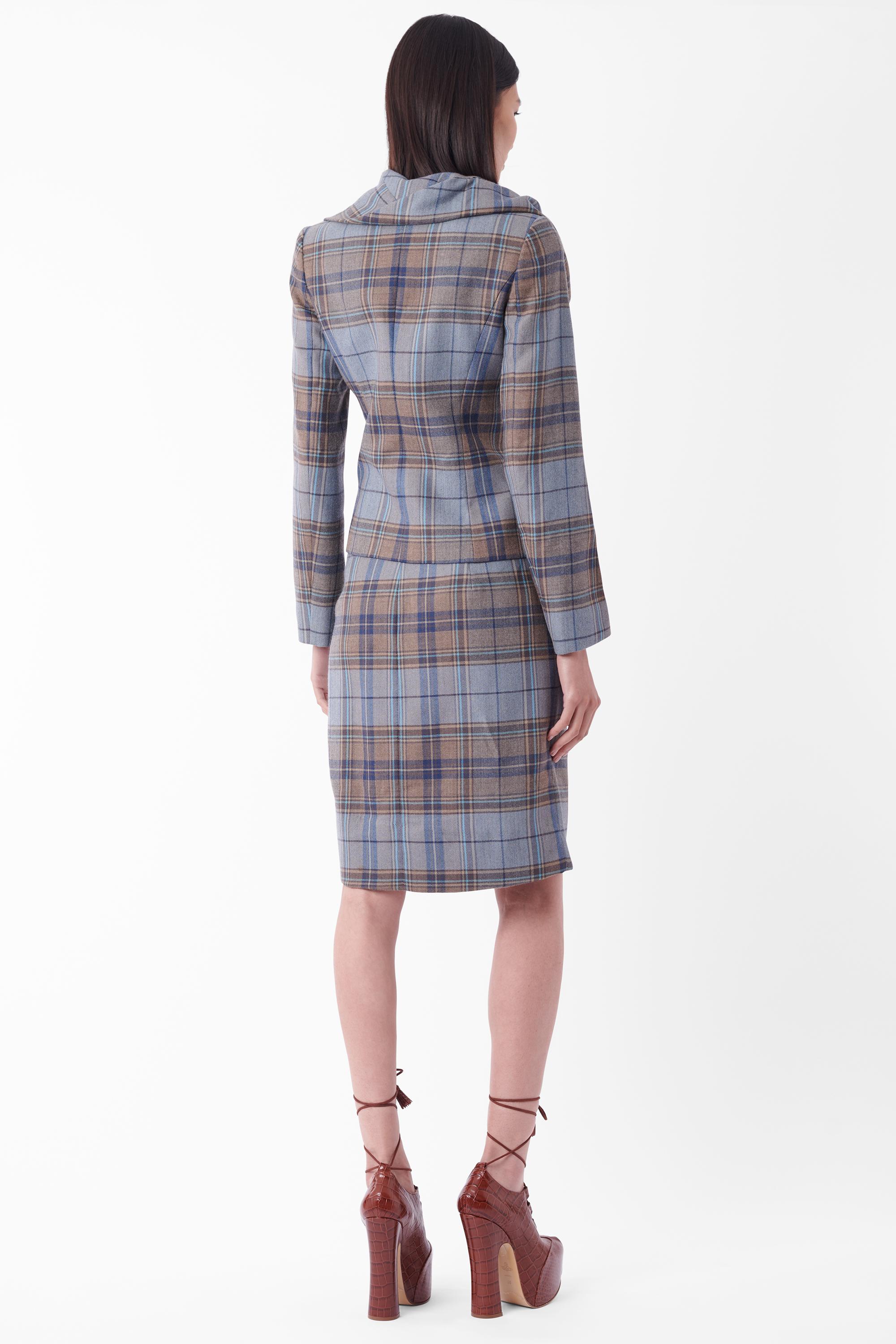 We are excited to present this Vivienne Westwood Fall Winter 2012 blue tartan set. Runways look 14 and 16. Jacket features a drunken asymmetric neckline, non-functioning pockets, orb printed button front closure, darted silhouette and red label tag.