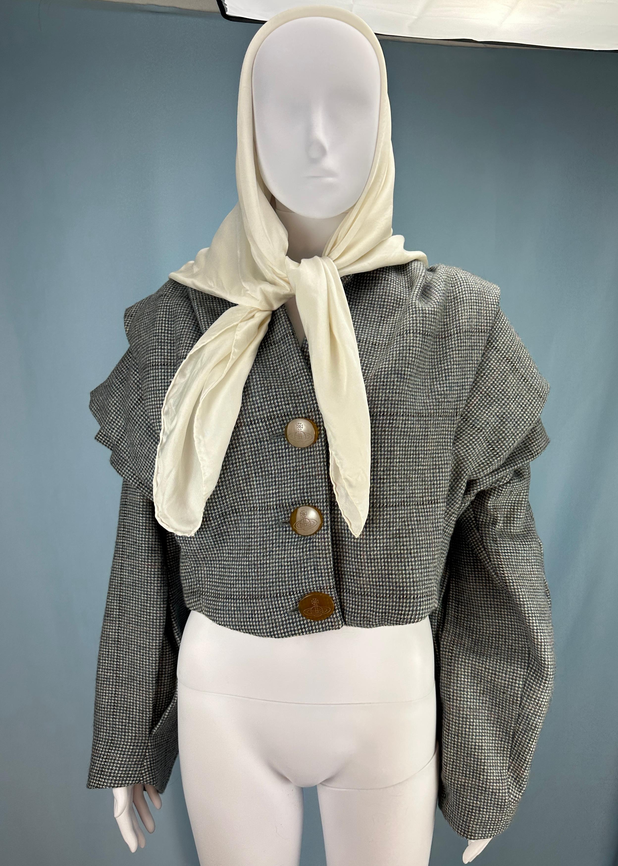 Vintage Vivienne Westwood

Fall 1992 “Always on Camera” collection 
Runway piece - this is the exact jacket that was worn on the Fall 1992 runway, the scarf is also presumed to also be the runway sample piece. 

Grey wool tweed “armour” jacket & dog
