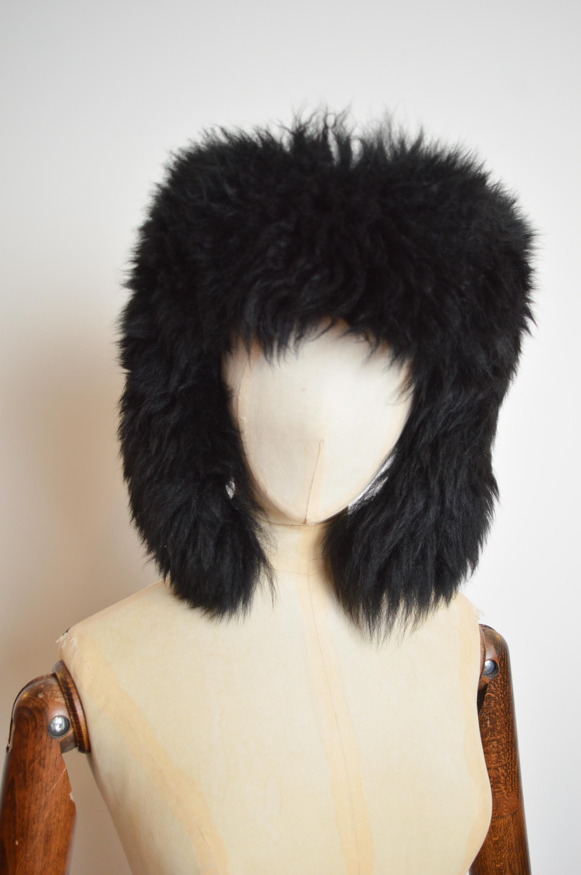 A Rare, Fall 1996 Museum worthy Vivienne Westwood Black Shearling Trapper Hat.   

MADE IN ENGLAND.  
Measurements are provided in Inches;
Length; 12” Approximately
Size; 23.5” Approximate head Circumference 
Condition; 10/10
Material; Sheepskin
