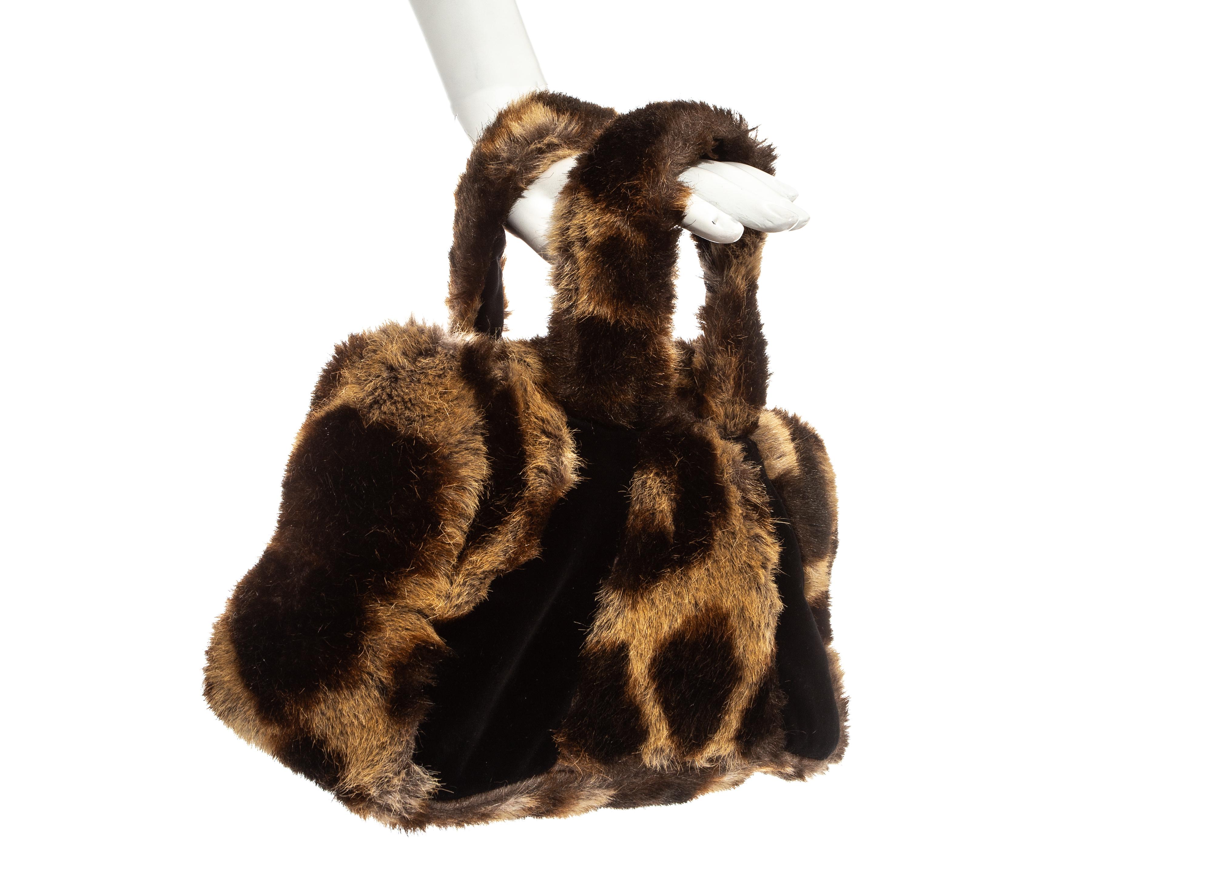 Vivienne Westwood faux fur bag in the signature animal print. Three gold Orb button fastening and satin lining.

Fall Winter 