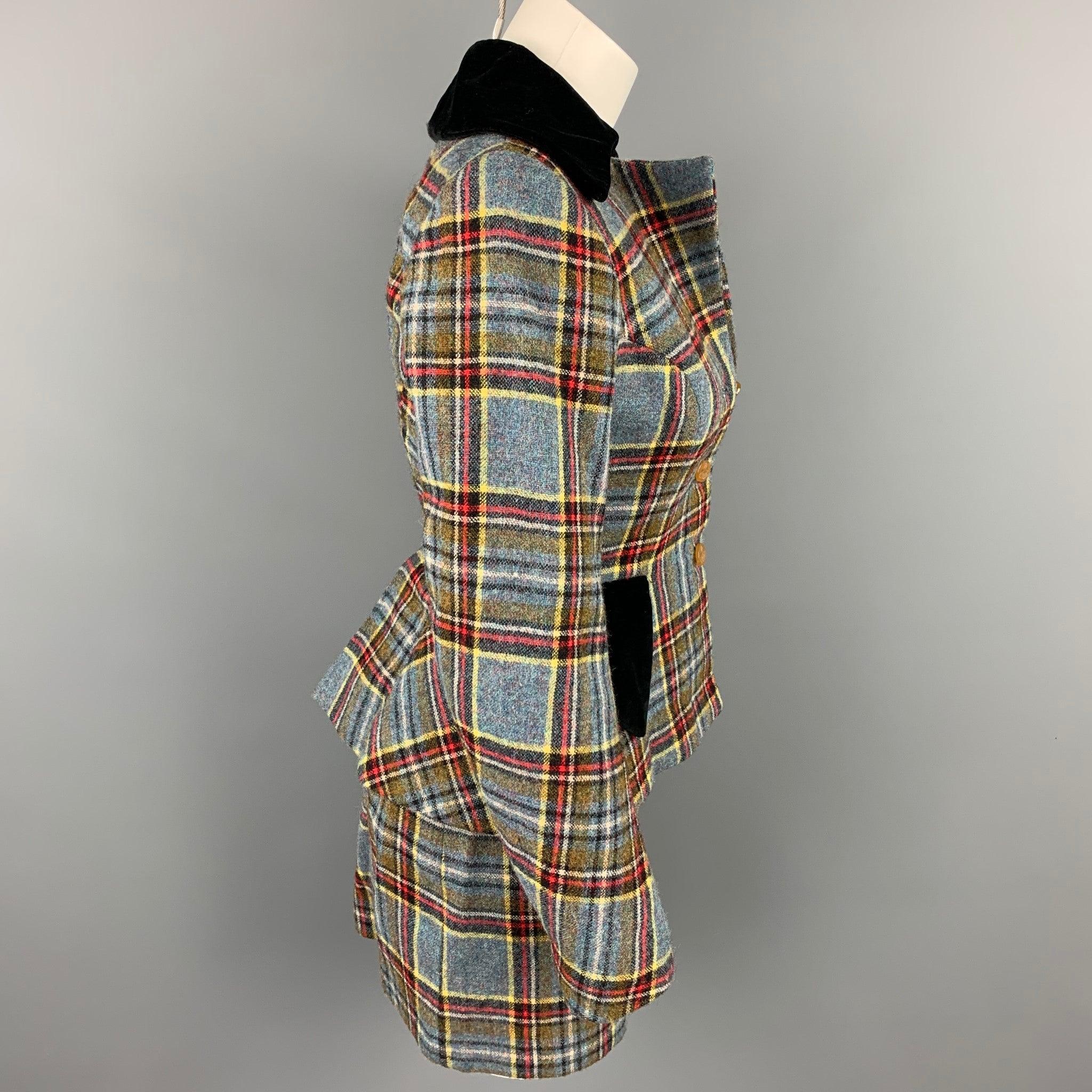 VIVIENNE WESTWOOD skirt suit from the iconic On Liberty Fall Winter 1994 collection comes in a blue & red plaid tartan wool with a full mono gram print liner featuring a velvet trim, a-line, flap pockets, and a three buttoned closure. Includes