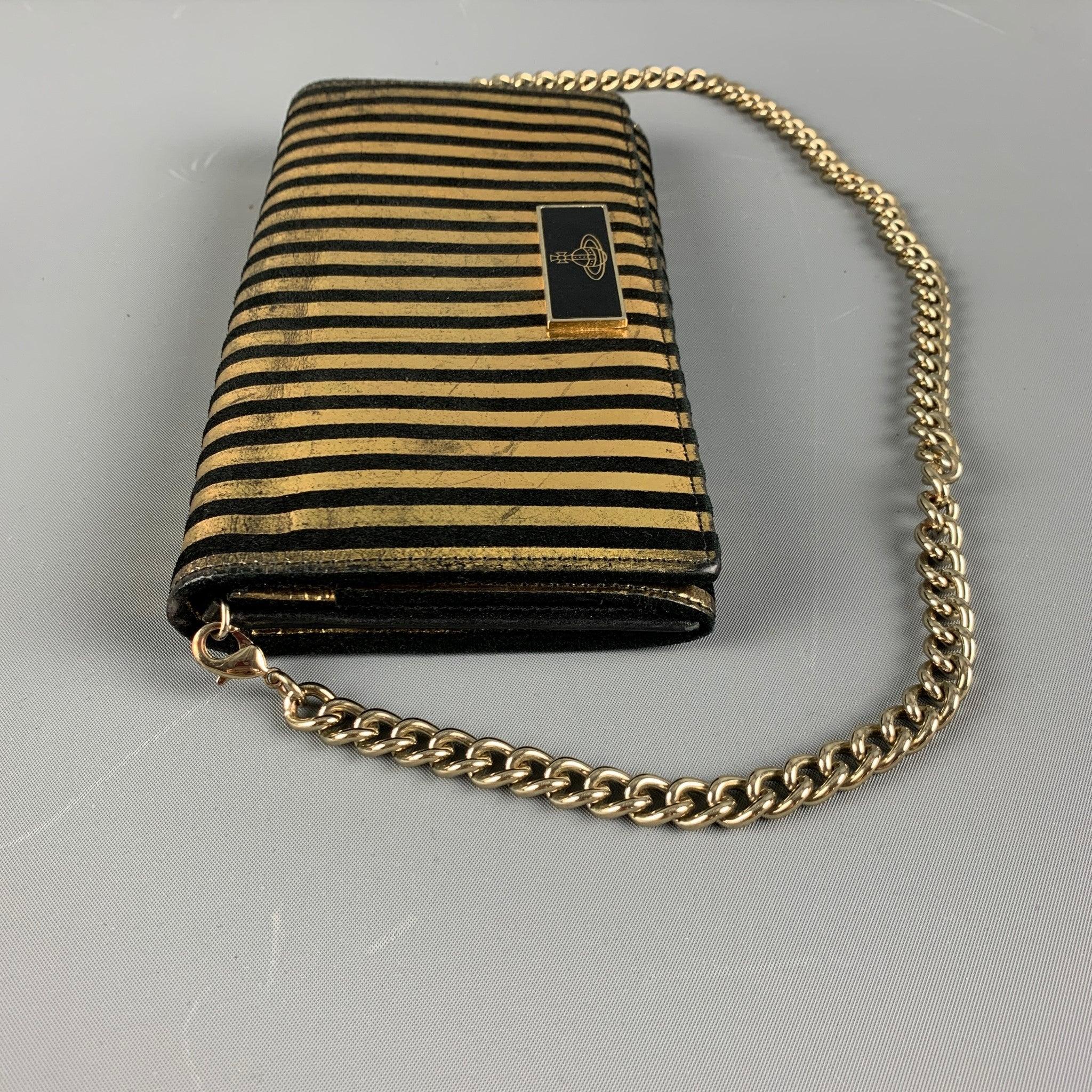 VIVIENNE WESTWOOD wallet handbag comes in a black and gold striped leather featuring inner slots, detachable gold tone chain strap, and a zipper pocket. Made in Italy.Very Good Pre-Owned Condition. Moderate color fading. 

Measurements: 
  Length: 8