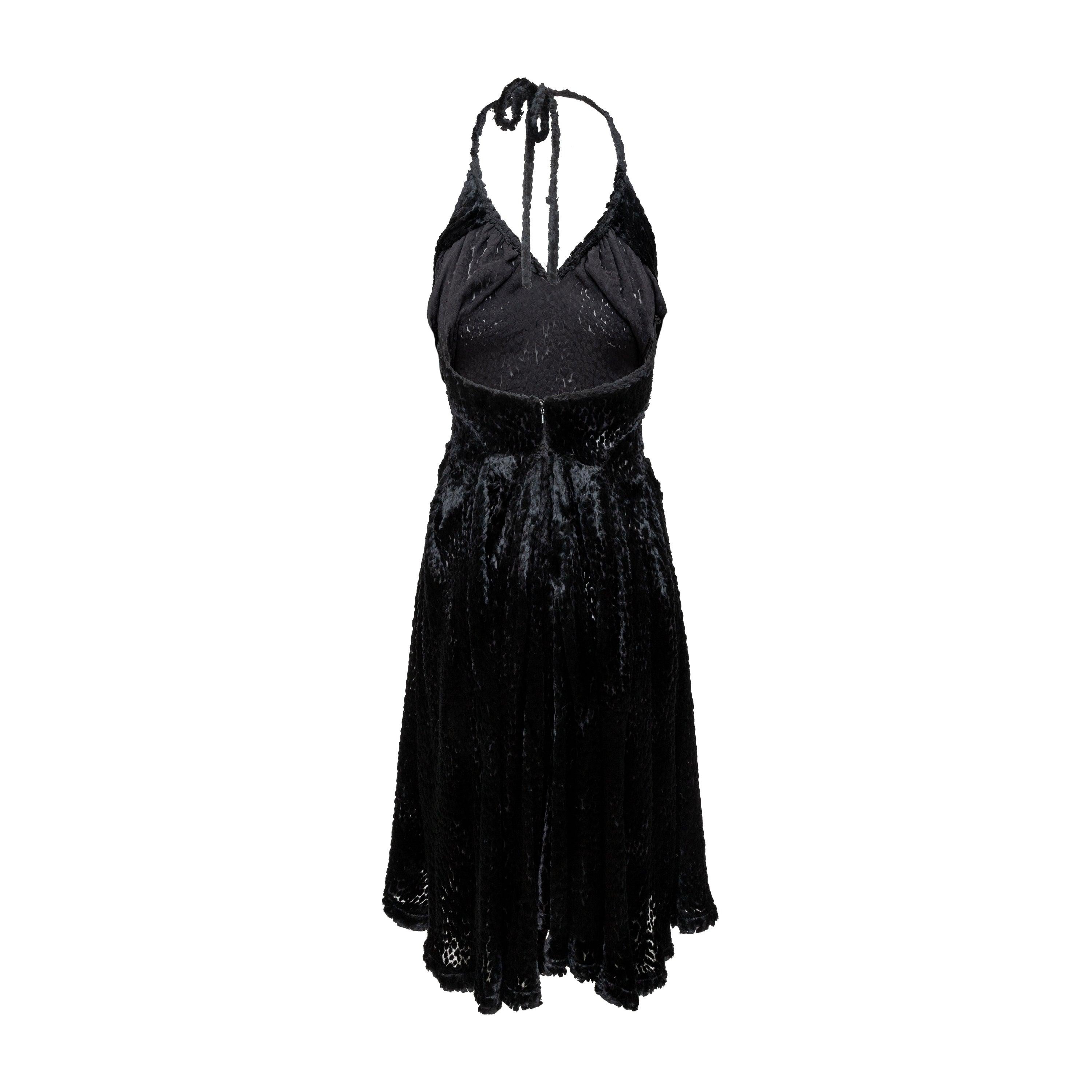 Made in England, the Vivienne Westwood Halter Dress by Andreas Kronthaler dates back to F/W 1994. Crafted with faux fur made of viscose & silk, the zip and hook eye tightening make it easy to slip into the dress and the hem is embellished with
