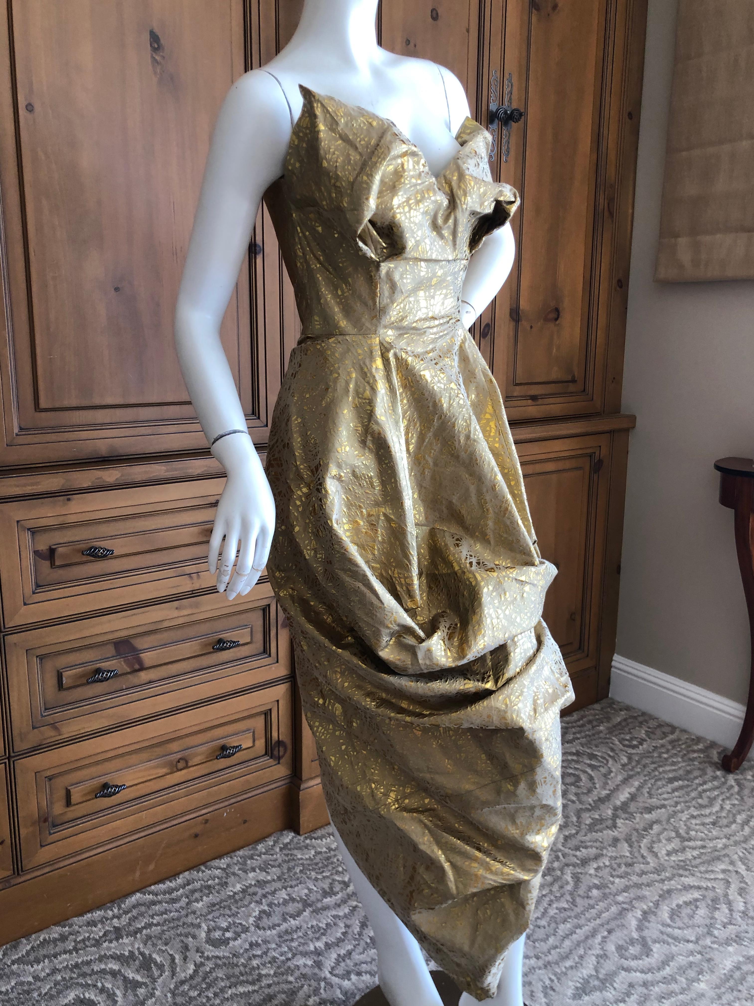 Vivienne Westwood Gold Label Elegant Gold Brocade Cocktail Dress with Built In Corset.
This has a strap and button inside that allows the wearer to go from long to short by hitching up the skirt.
From 2017
 Built in corset, a Westwood