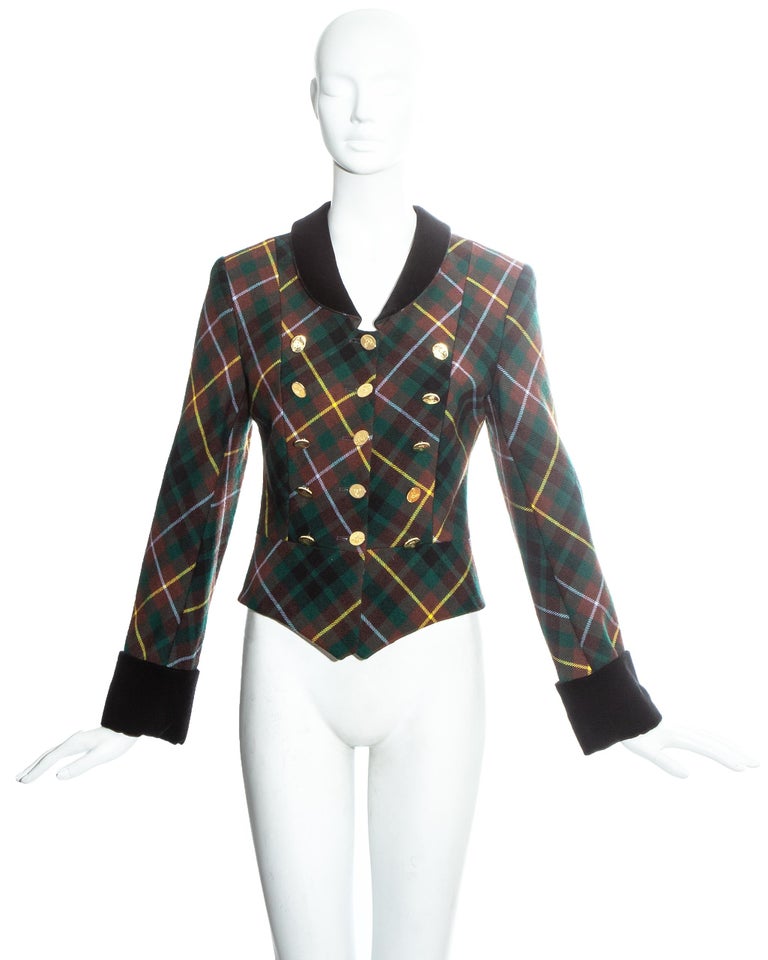 Vivienne Westwood green tartan wool fitted jacket with 15 gold orb button fastenings at front. Black velvet cuffs and collar.

Fall-Winter 1988
