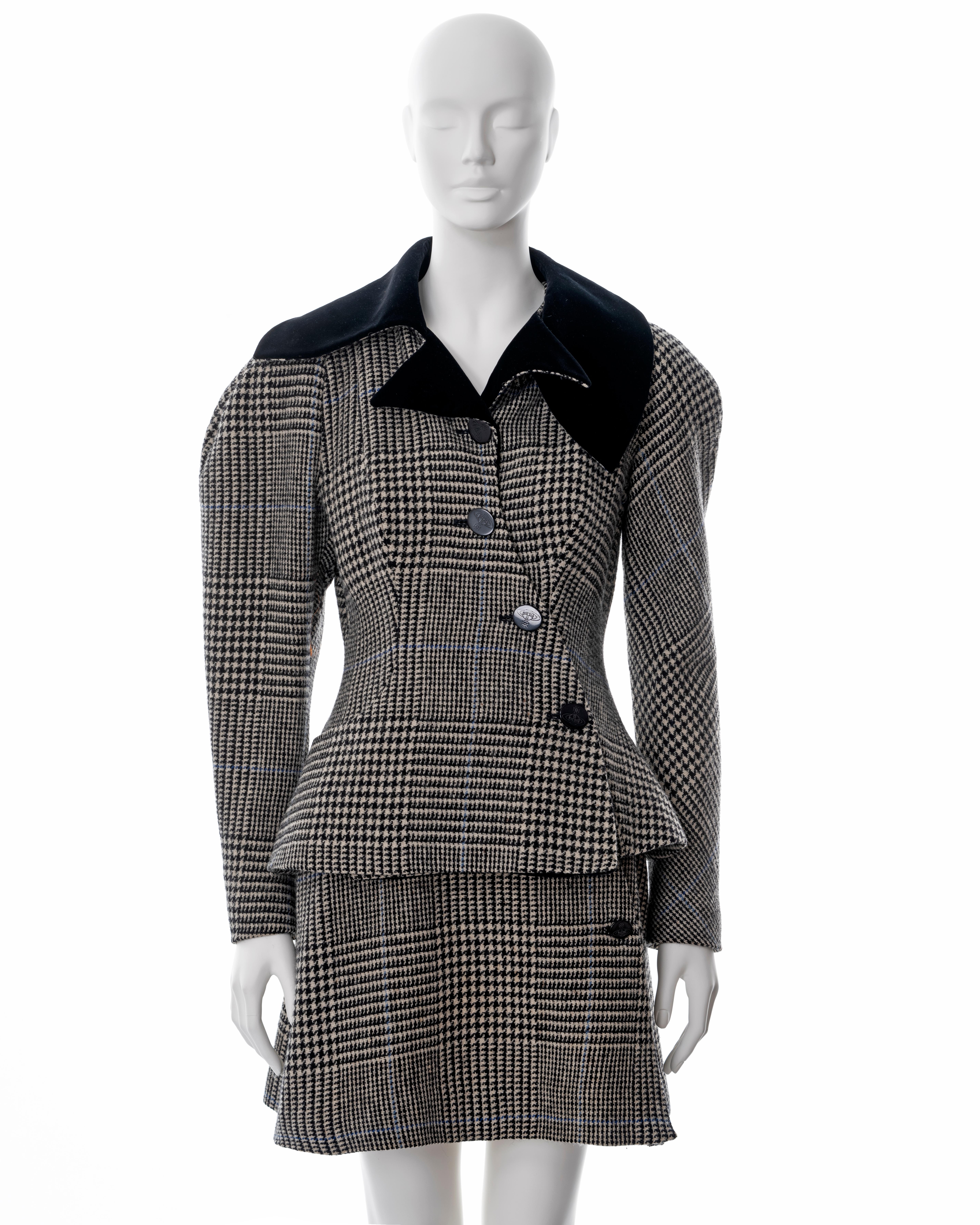 ▪ Vivienne Westwood grey houndstooth-check tweed skit suit
▪ Sold by One of a Kind Archive
▪ Fall-Winter 1996
▪ Harris Tweed 
▪ Asymmetric cut
▪ Hourglass shape 
▪ Leg-of-Mutton sleeves 
▪ Black velvet collar 
▪ Matching mini skirt 
▪ UK 10 - FR 38