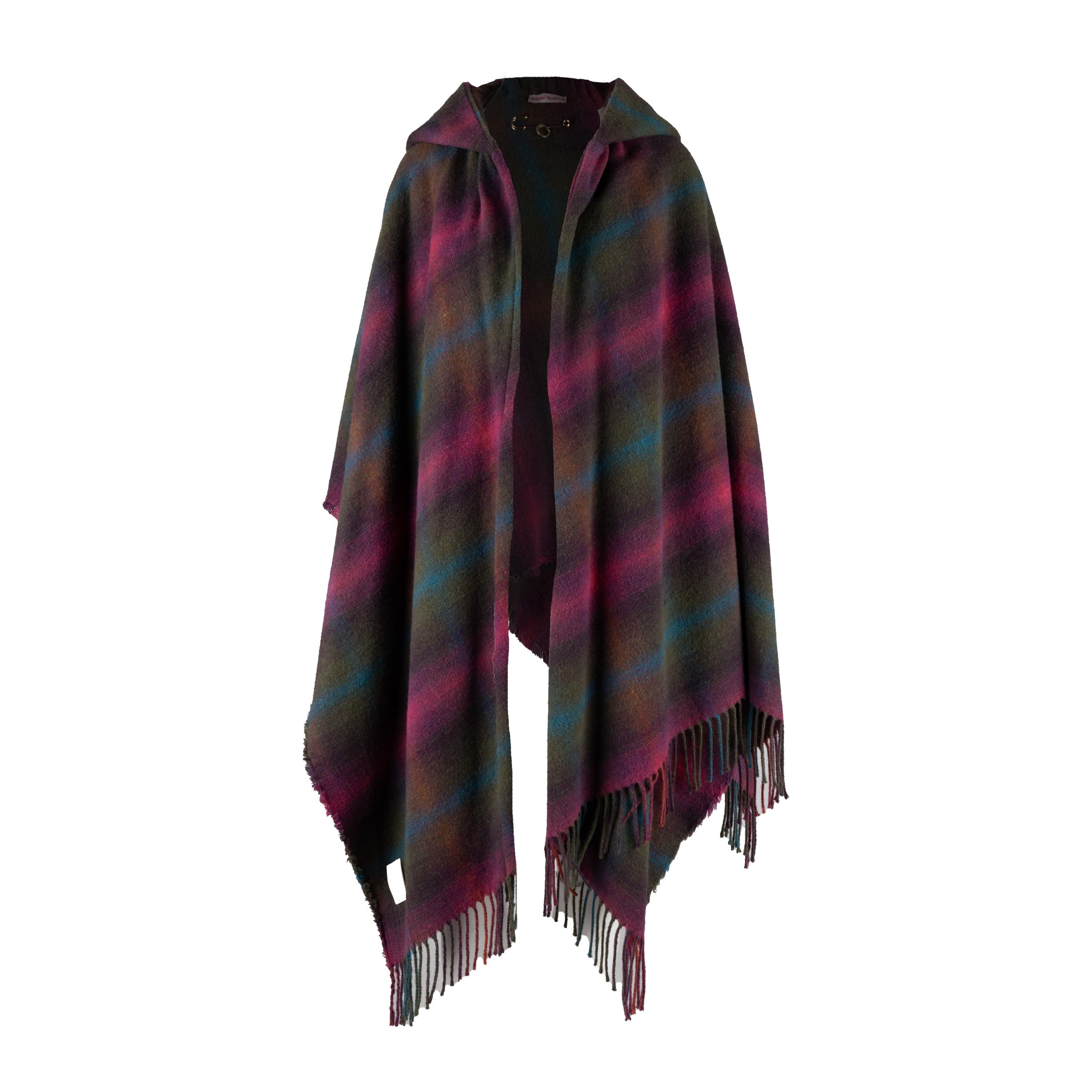 Step out in style with this double-layered, hooded Vivienne Westwood poncho. Crafted from a wool and acrylic blend fabric with a signature tartan plaid print, this poncho is finished off with a logo embossed pin to close the front and fringes at the