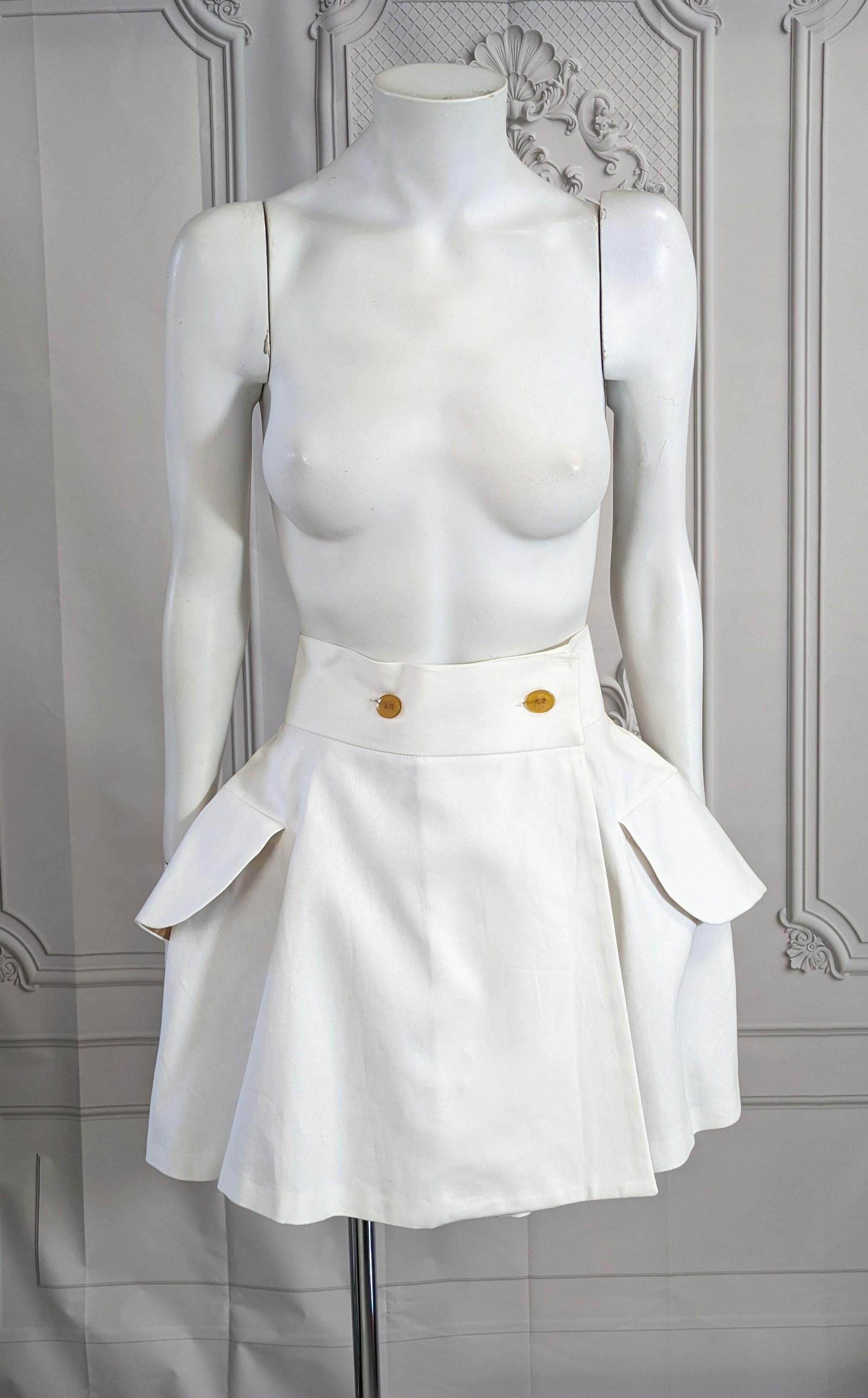 Vivienne Westwood Iconic White Twill Skirt with signature faux horn buttons. Full circle skirt wrapped mini with large faux flap pockets and back vent. Size 42 IT, 6 US, 10 UK Fully lined.
1990's UK. Waist is approx 26-27