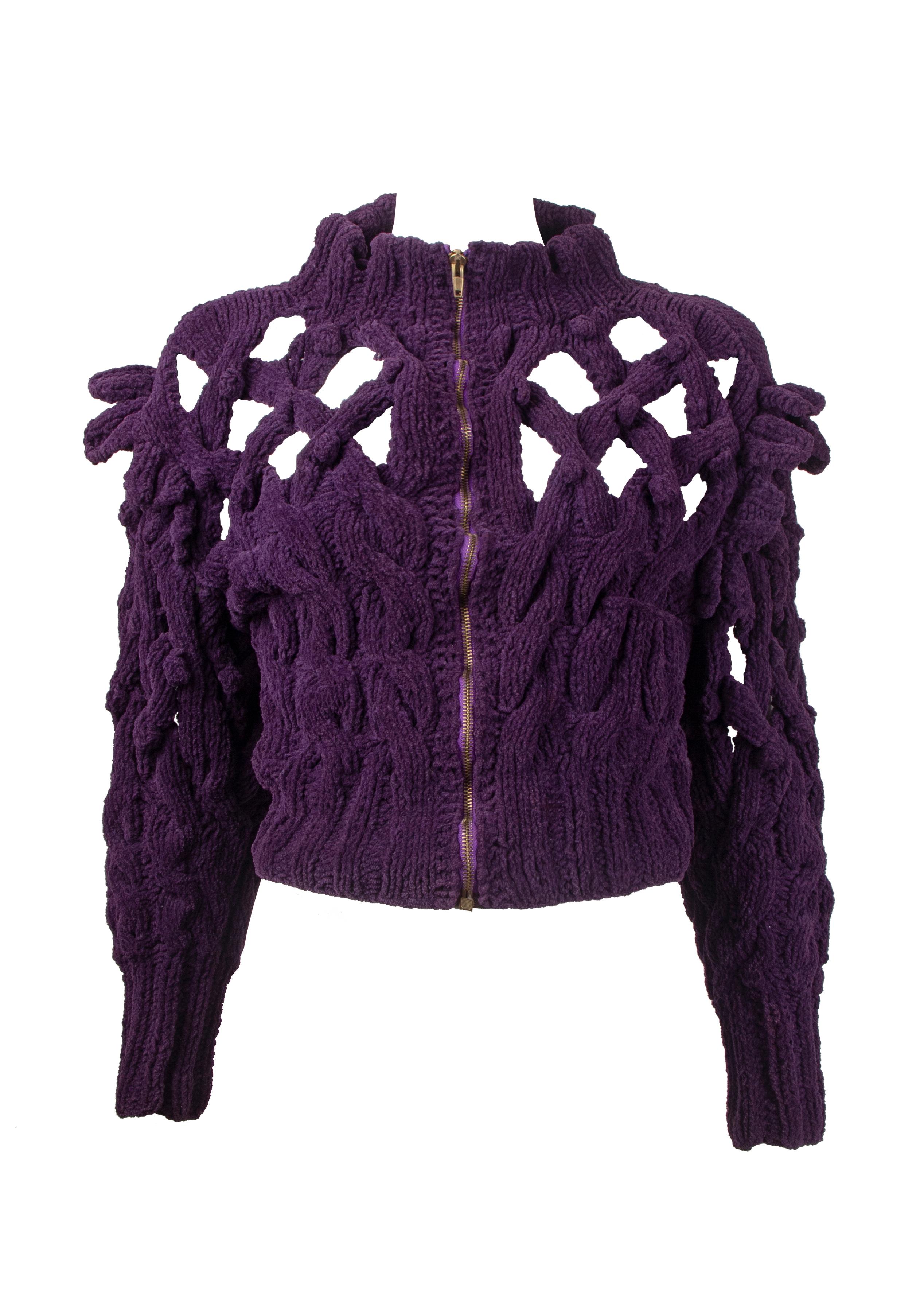 A Vivienne Westwood 'Cut, Slash and Pull' chenille jacket, Spring-Summer 1991. This Elizabethan inspired knitted jacket features knotted crosses to the upper body cascading down to intricate cable-knits and vertical ribbing. Other features include a