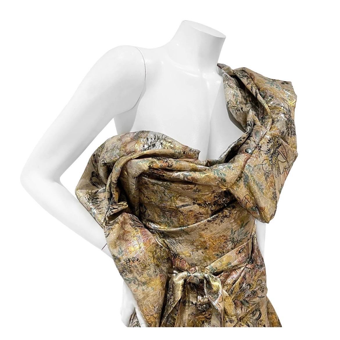 Layered Floral Corset Wrap Gown by Andreas Kronthaler for Vivienne Westwood 
Fall 2017
Made in Italy
Gold metallic 
Floral print detail throughout gown
Layered wrap gown
Large ruffle bow embellishment on top of gown
Strapless with single strap on
