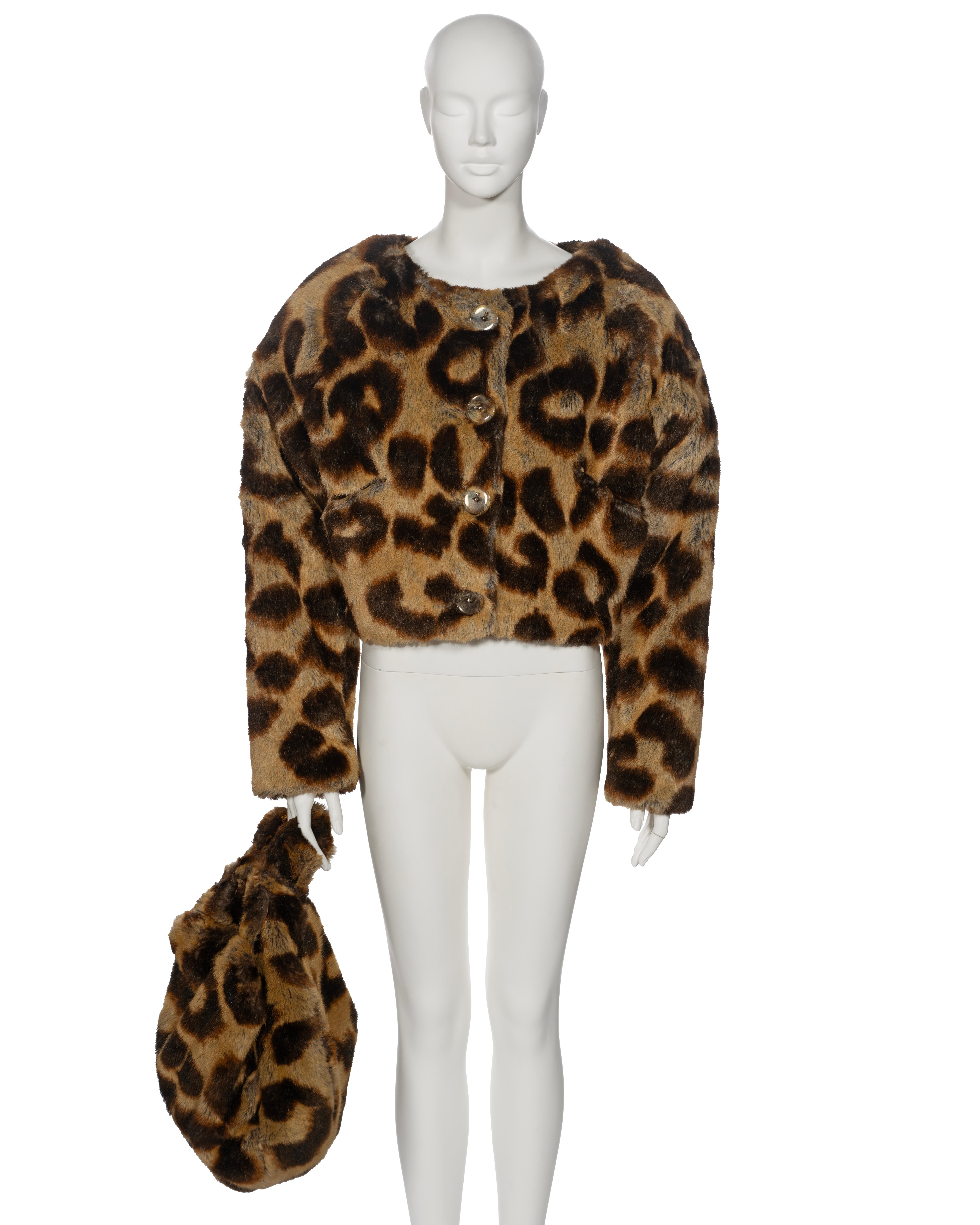 ▪ Archival Vivienne Westwood Faux Fur Jacket and Bag Set
▪ Always on Camera Collection, Fall-Winter 1992
▪ Sold by One of a Kind Archive
▪ Outsized leopard print on faux fur
▪ Rounded padded shoulder
▪ Clear resin button front with metal orb