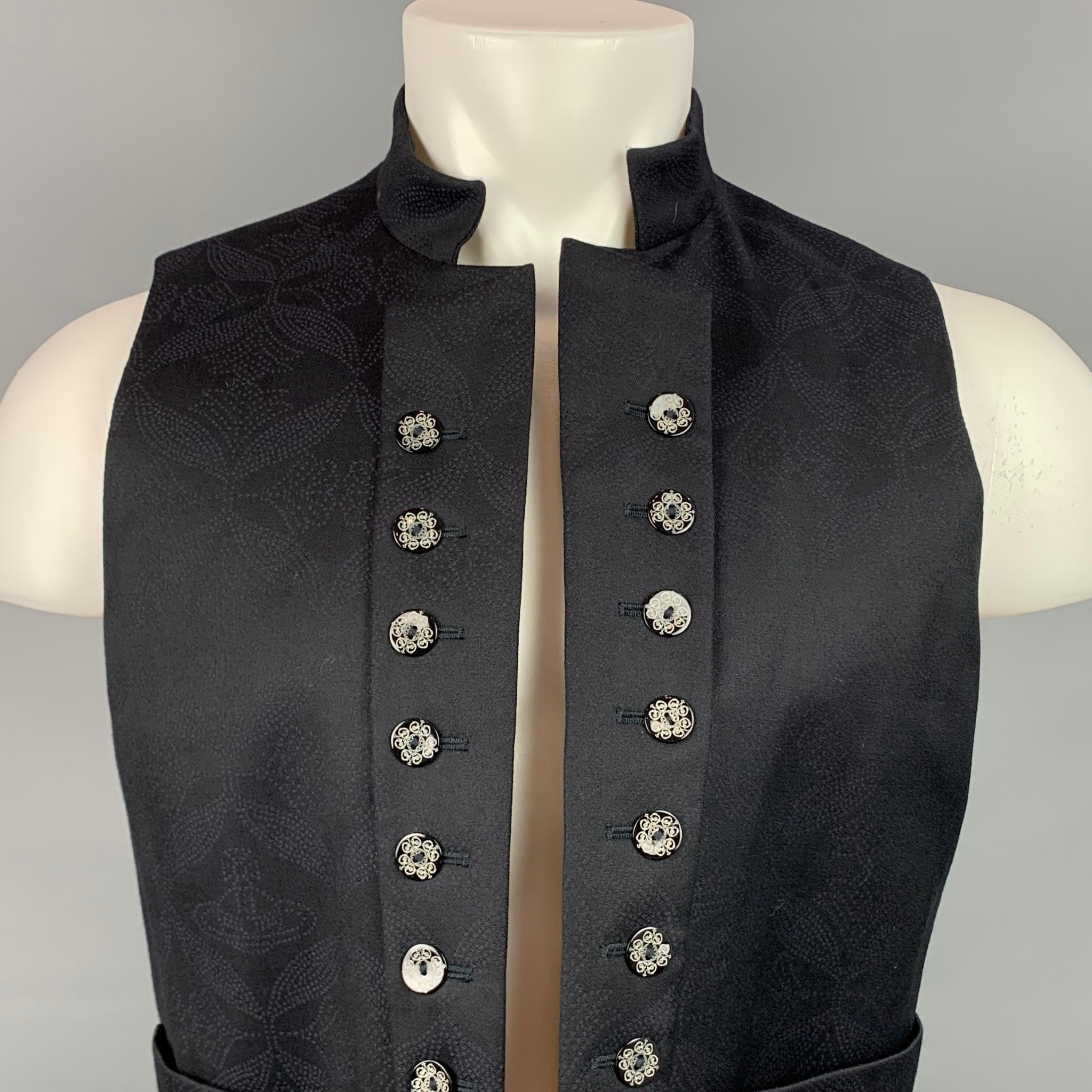 VIVIENNE WESTWOOD MAN vest comes in a black print wool with a full liner featuring buttoned details, slit pockets, and a open front. Made in Italy.

Excellent Pre-Owned Condition.
Marked: IT 50 / 2014

Measurements:

Shoulder: 14.5 in.
Chest: 38