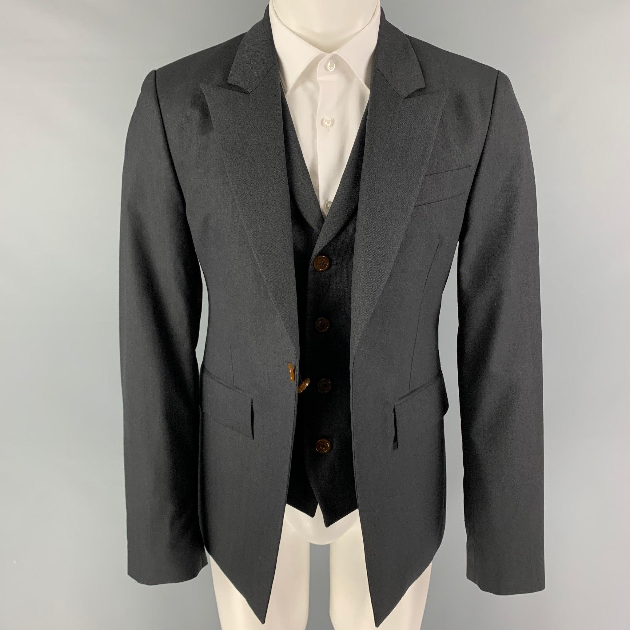 VIVIENNE WESTWOOD MAN sport coat comes in a charcoal wool with a full liner featuring a peak lapel, simulated vest layer, flap pockets, single back vent, and a single button closure. Made in Italy.
Excellent
Pre-Owned Condition. 

Marked:   50