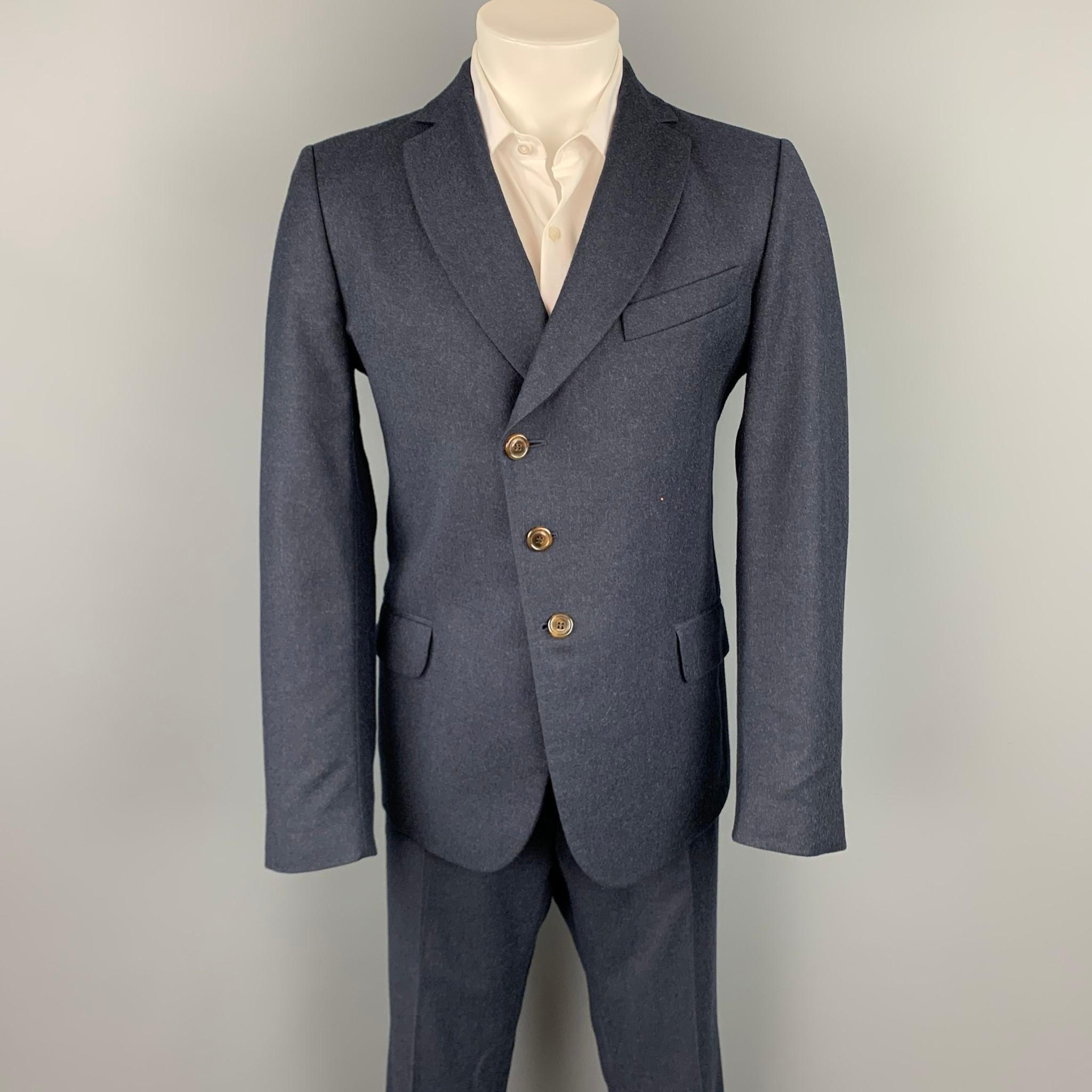 VIVIENNE WESTWOOD MAN suit comes in a navy wool with a full print liner and includes a single breasted,  three button sport coat with a notch lapel and matching flat front trousers. Made in Italy.

Excellent Pre-Owned Condition.
Marked: IT