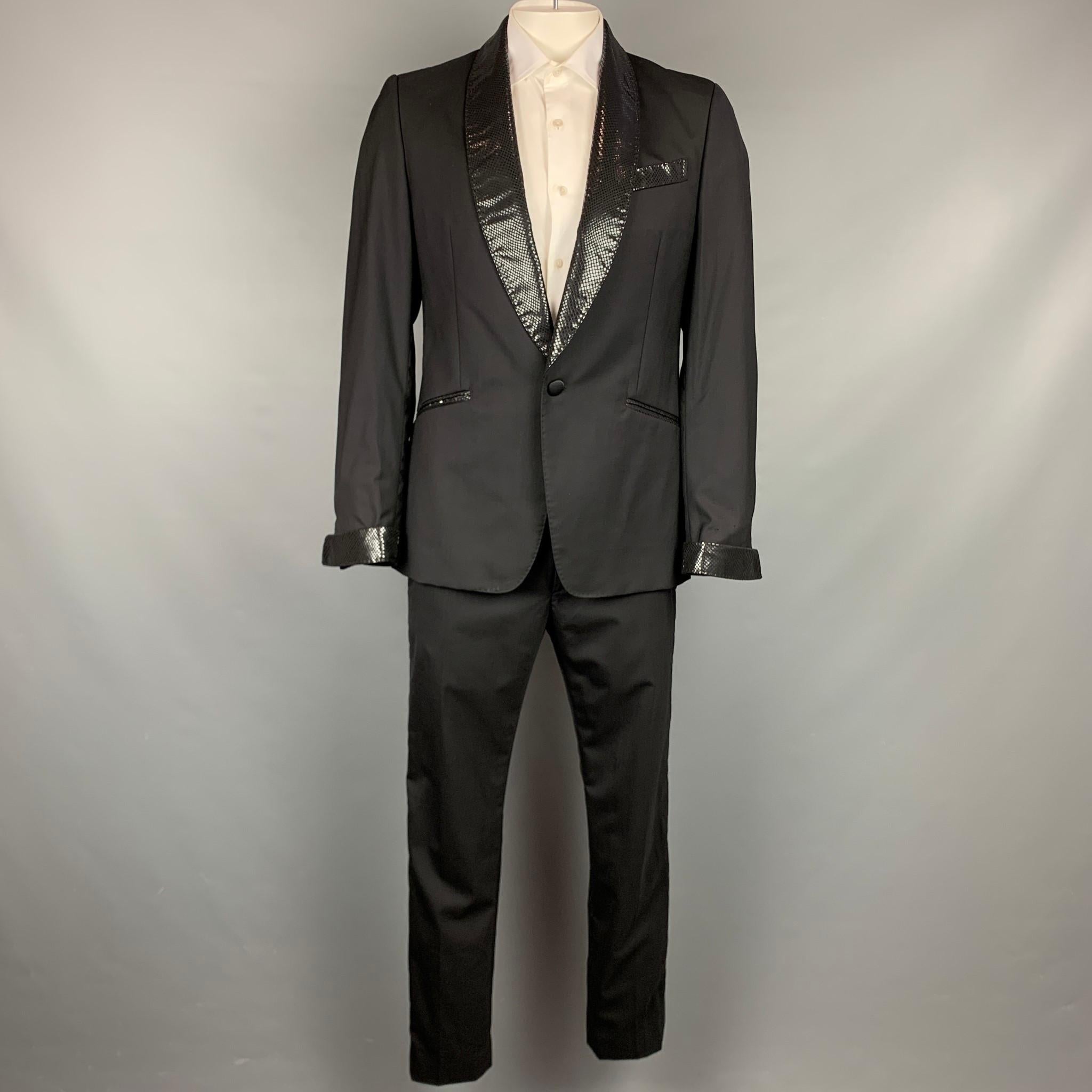 VIVIENNE WESTWOOD MAN suit comes in a black wool with a full liner and includes a slim fit, single breasted,  single button sport coat with shal collar and matching flat front trousers. Made in Italy.

Excellent Pre-Owned Condition.
Marked: Jacket:
