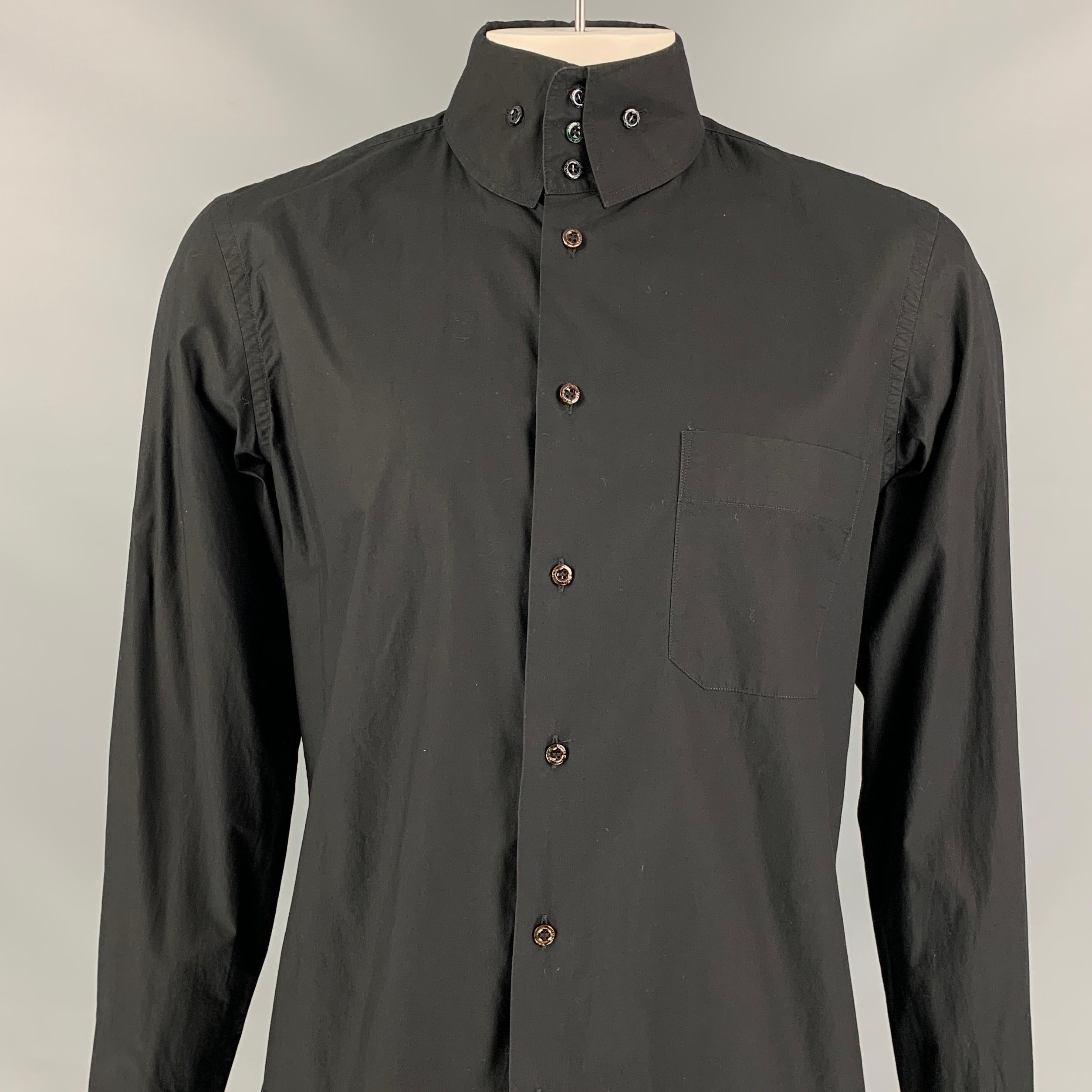 VIVIENNE WESTWOOD MAN long sleeve shirt comes in a black cotton featuring a wide buttoned collar, patch pocket, embroidered logo detail, and a button up closure. Made in Italy. 

Very Good Pre-Owned Condition.
Marked: V

Measurements:

Shoulder: