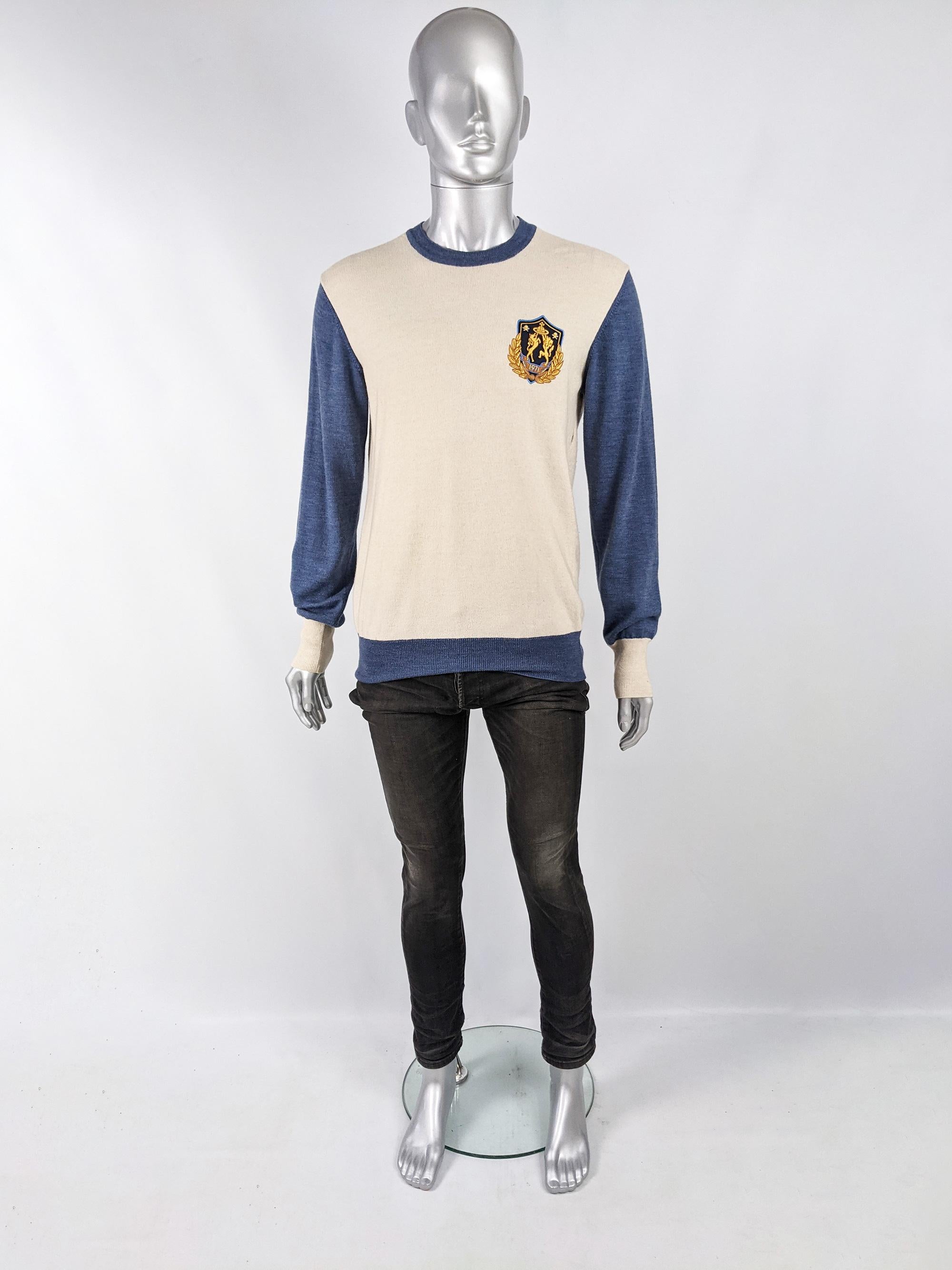 An excellent archival Vivienne Westwood mens crew neck sweater from the Autumn Winter 2011 collection. Made in Italy, from a cream wool blend knit with blue sleeves and an embroidered badge on the chest. 

Size: Marked M. Please check measurements.