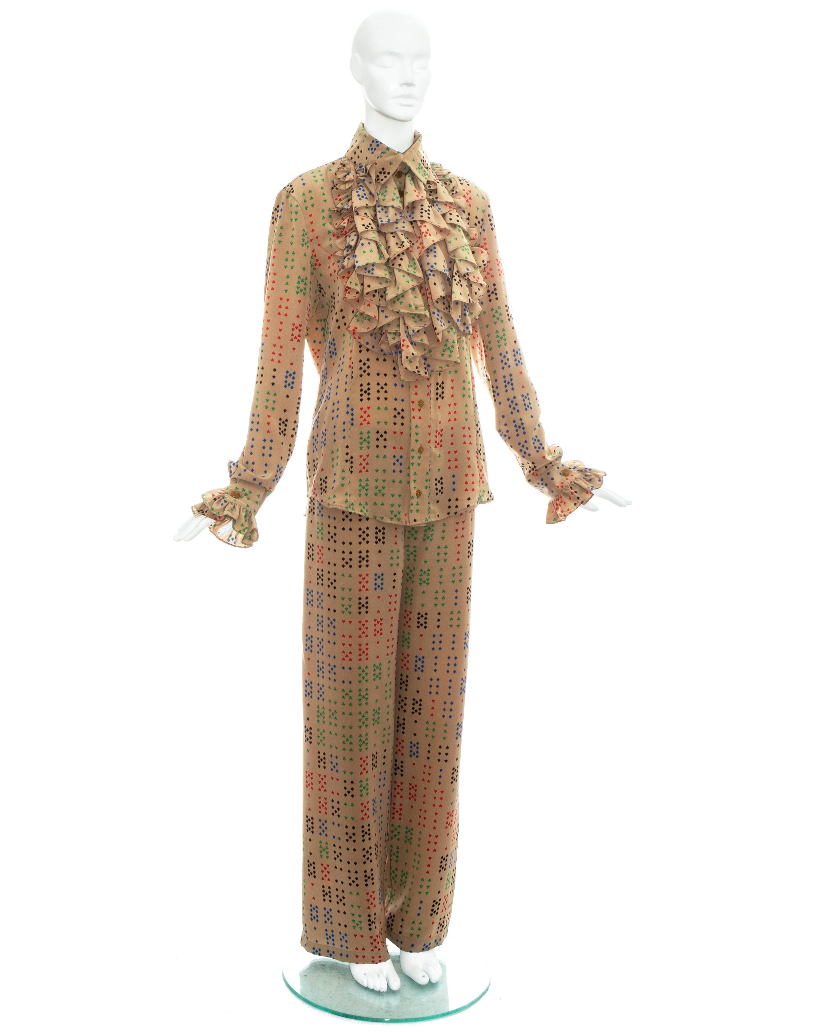 Vivienne Westwood men's tan polyester pant suit with playing card symbols print. Wide leg pants with elastic waistband and ruffled shirt.

Spring-Summer 1997
