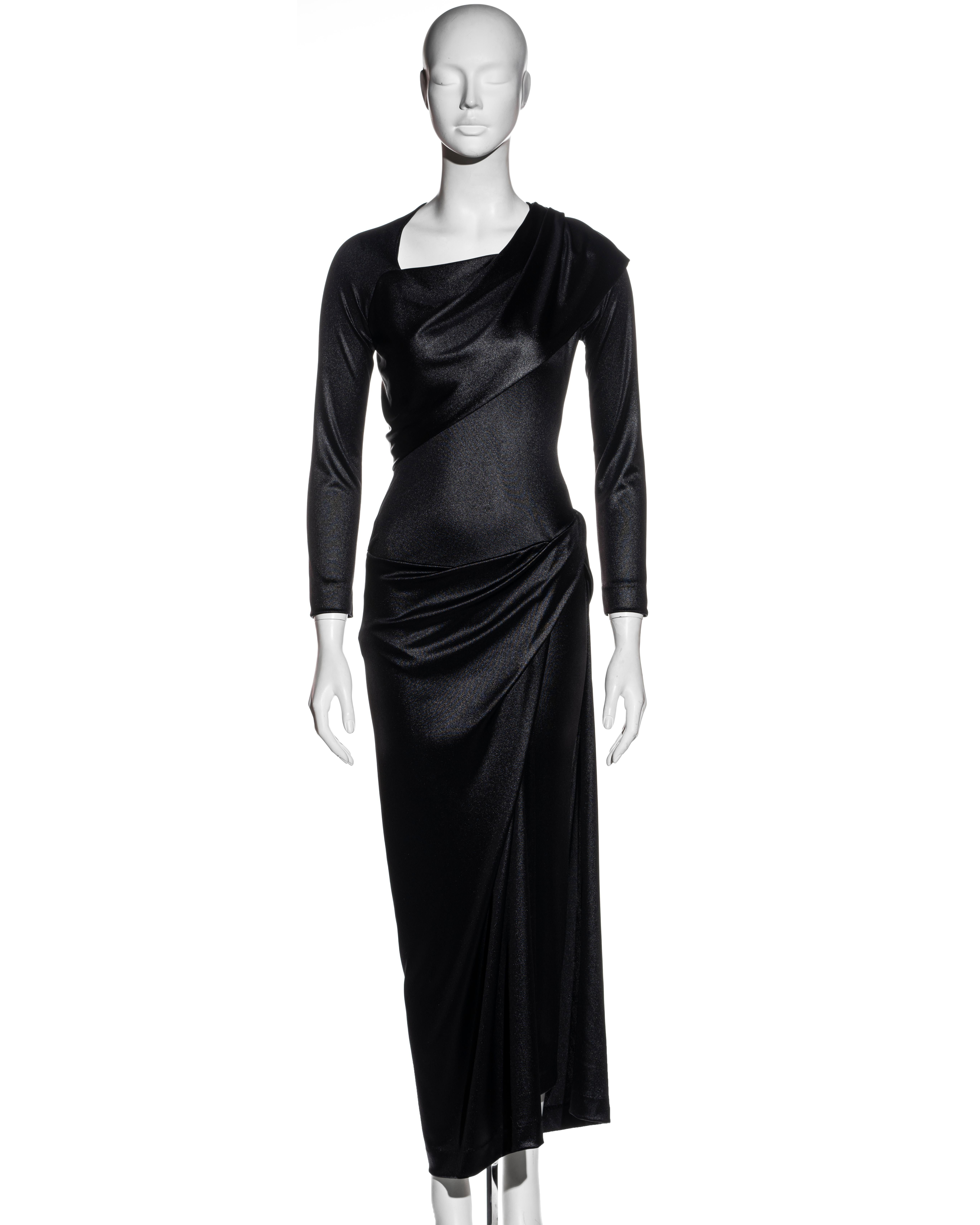 ▪ Vivienne Westwood metallic black nylon jersey evening dress
▪ Draped skirt with high leg slit 
▪ Fitted bodice 
▪ Draped panels at the bust and shoulders 
▪ Asymmetric neckline 
▪ UK 12 - Medium
▪ Fall-Winter 1997