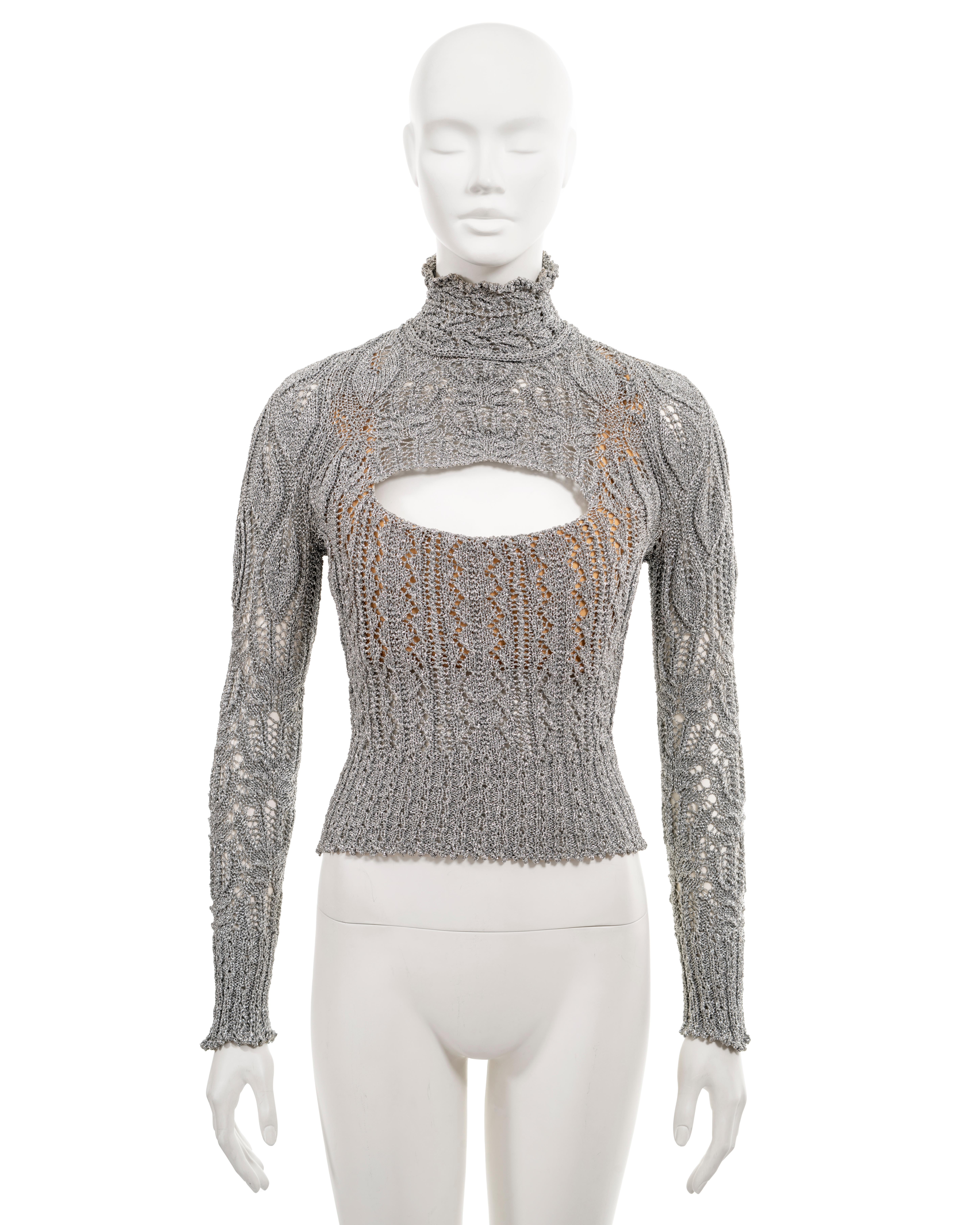 ▪ Vivienne Westwood archival corset-sweater
▪ Sold by One of a Kind Archive
▪ Fall-Winter 1993
▪ Open-knit in metallic silver yarn
▪ Built-in nude corset
▪ Cutout at the chest 
▪ High neck
▪ Long fitted sleeves 
▪ Size 'Large' (runs smaller)
▪ Made