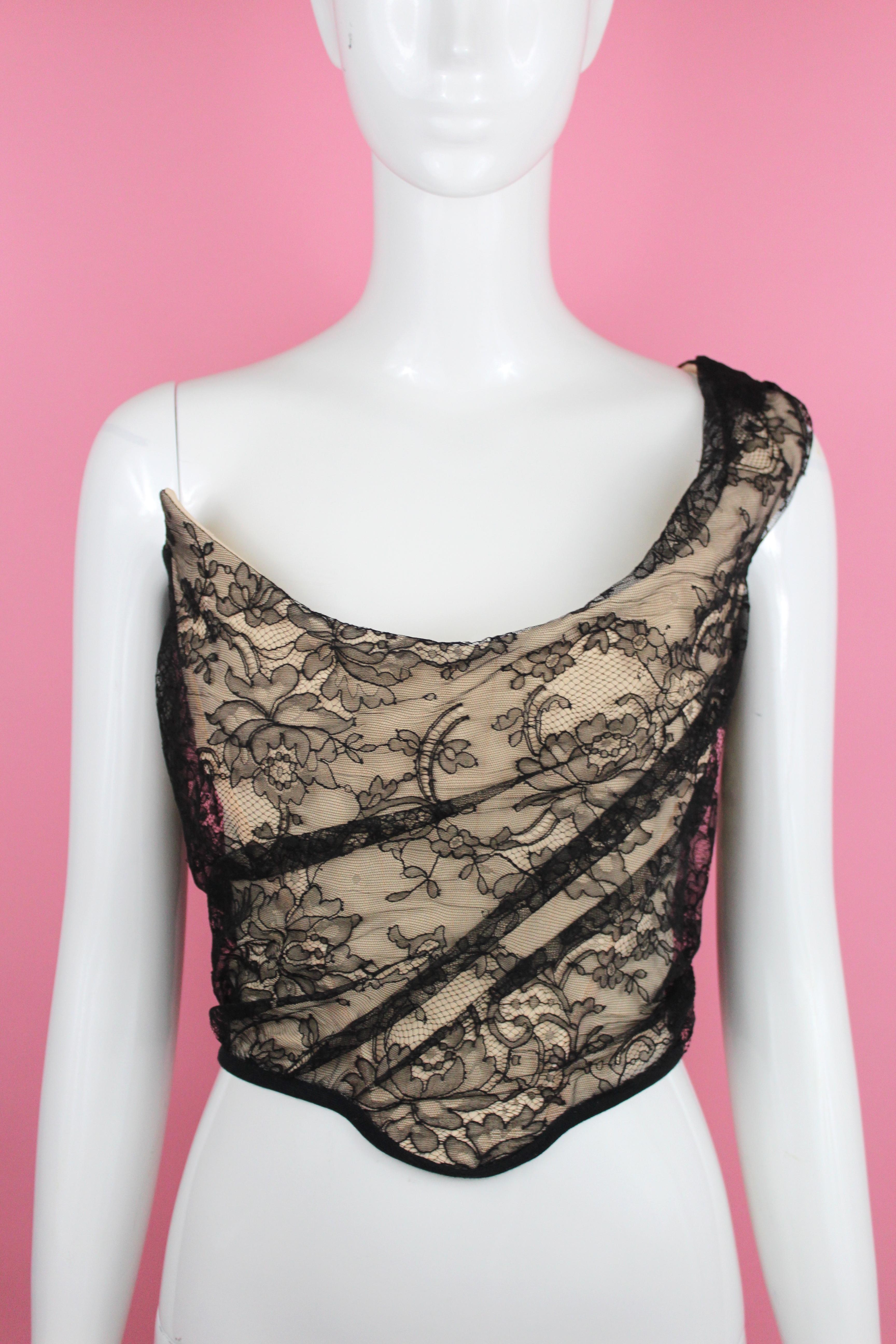 -Gorgeous corset from Vivienne Westwood, nude with black lace overlay
-Has stretch side panels
-Has bow in the back (not detachable) 
-Made in England
-Sized 12 UK, which corresponds with an 8 us, but fits a bit smaller, at best a US 6

Approximate