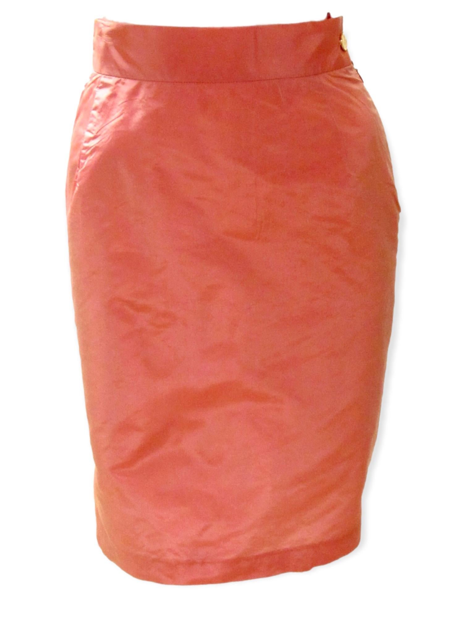 A lustrous pink satiny pencil skirt from vintage Vivienne Westwood is an absolute standout! Side zip with signature logo button closure and back slit. 