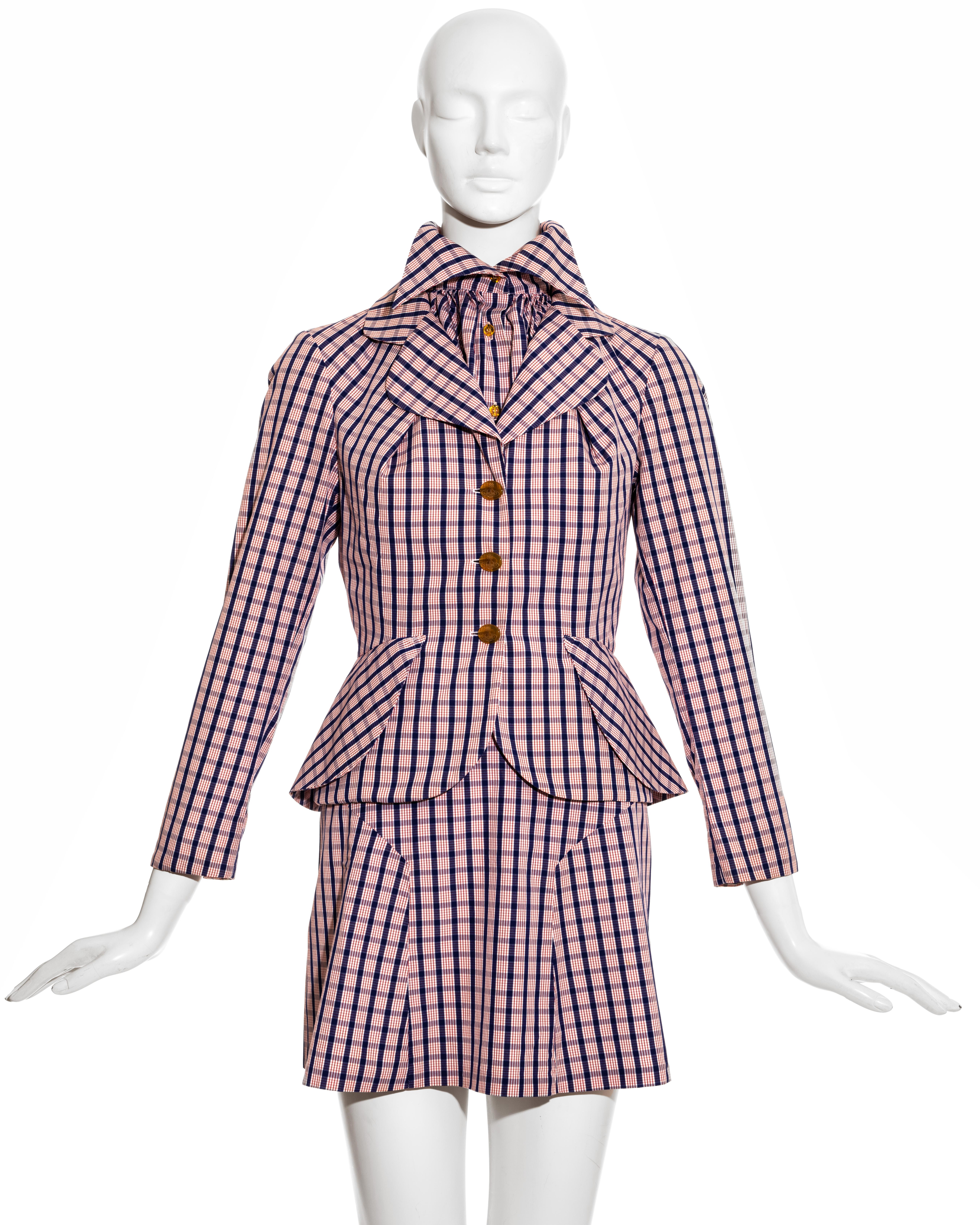 Vivienne Westwood red and blue checked cotton three piece suit comprising: halter neck blouse with high-neck pointed collar and draped bust, fitted blazer jacket with signature orb buttons and high waisted pleated mini skirt.

Cafe Society,