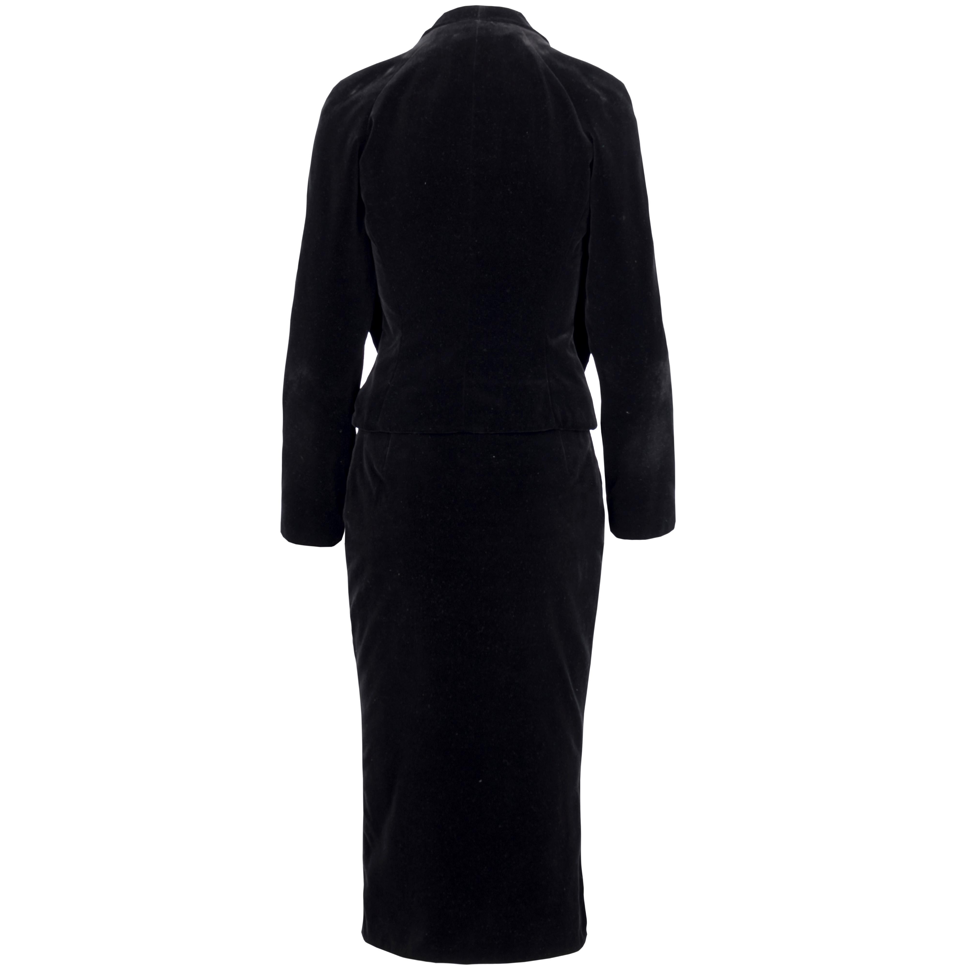 Ideal for a soirée, the Vivienne Westwood black velvet suit showcases a dual flap layered top with a curved neckline and golden emblem embossed buttons and a long black velvet pencil skirt. The red and golden logo tag is attached to the cream satin