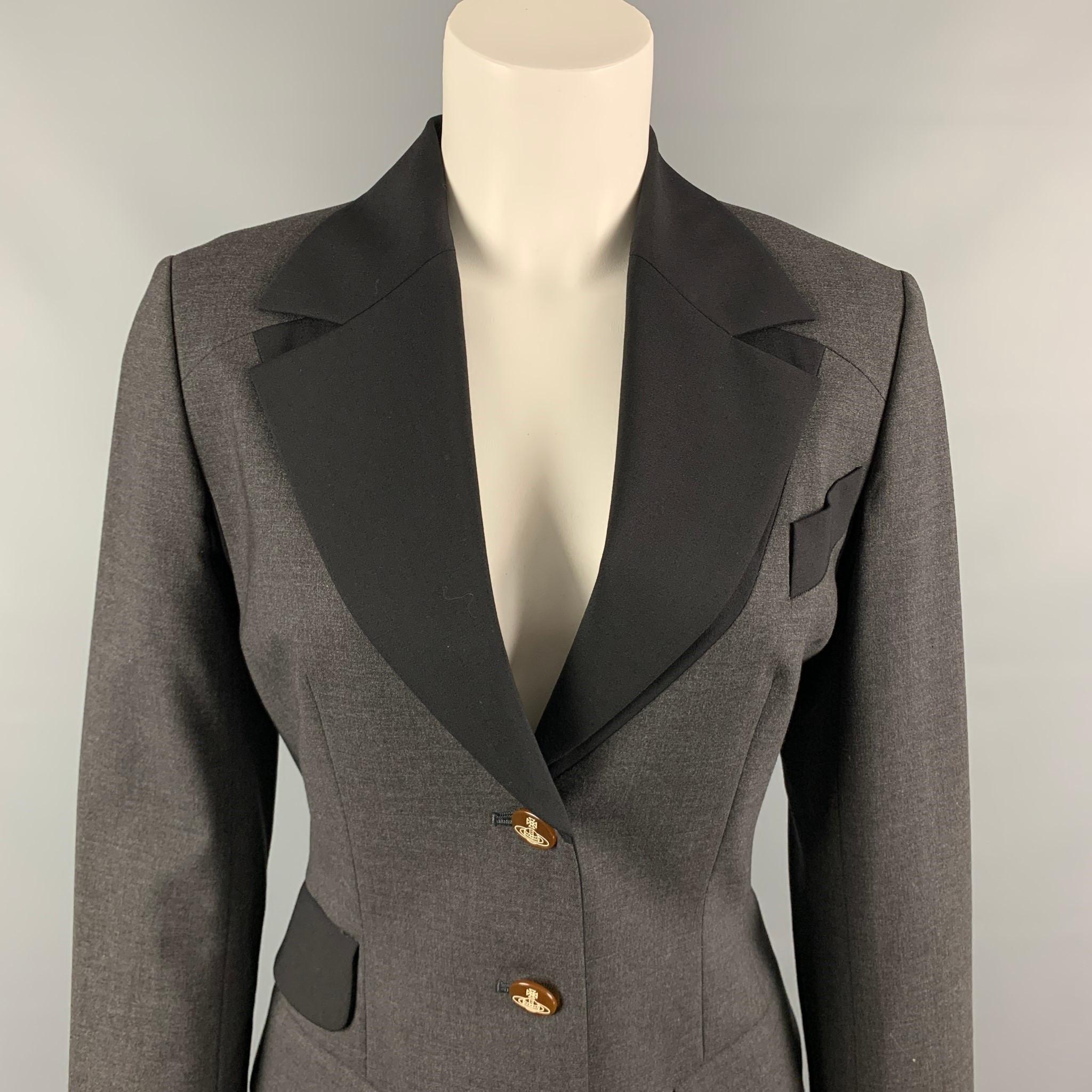 VIVIENNE WESTWOOD RED LABEL jacket comes in a charcoal & black color block with a full monogram print liner featuring a wide collar, flap pockets, and a buttoned closure.

Very Good Pre-Owned Condition.
Marked: 2

Measurements:

Shoulder: 15.5